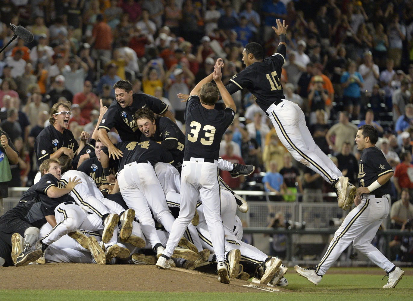 Vanderbilt players, including John Norwood (10), celebrate after defeating Virginia 3-2 in the deciding game of the best-of-three NCAA baseball College World Series finals in Omaha, Neb., Wednesday, June 25, 2014.