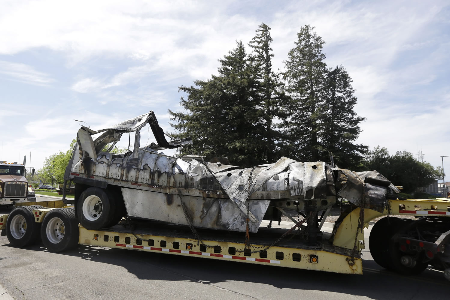 The demolished remains of a FedEx truck is towed into a CalTrans maintenance station in Willows, Calif., on Friday.