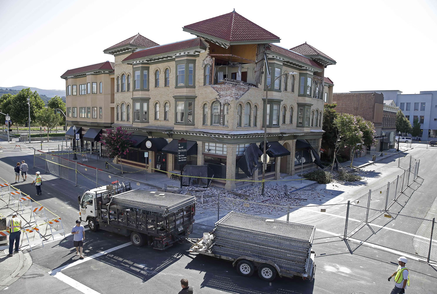 Photos by Eric Risberg/Associated Press
A truckload of fencing is brought to Second Street outside the earthquake-damaged building that housed the Carpe Diem wine bar Tuesday in Napa, Calif. A number of blocks were fenced off in the downtown area.