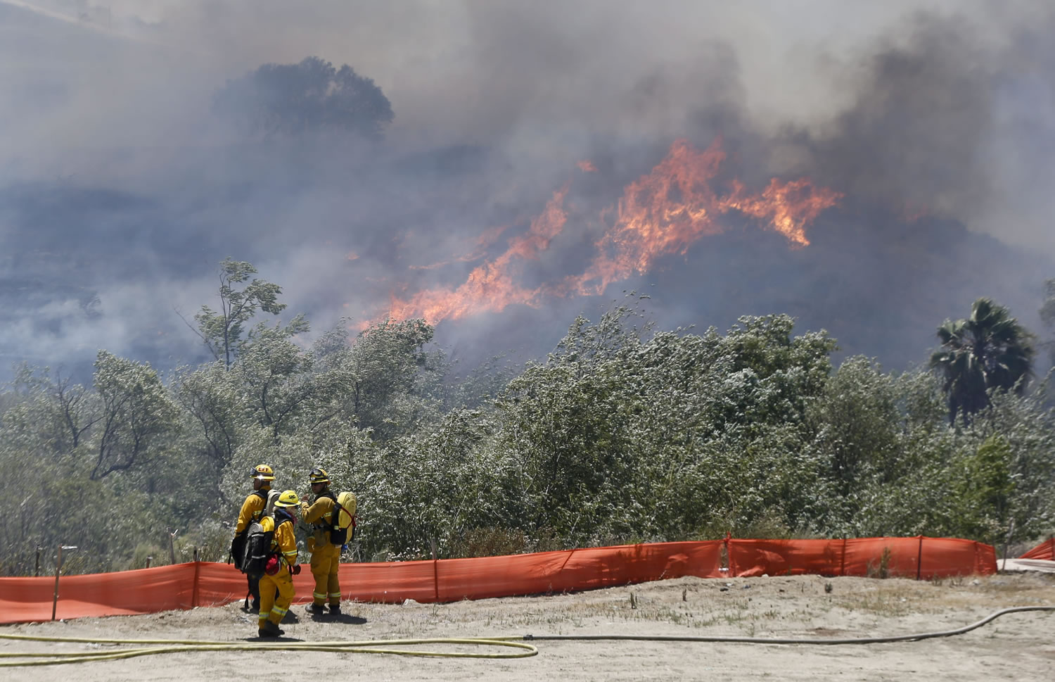 Flames grow as a wild fire burns out-of-control in the north county area of San Diego on Tuesday.