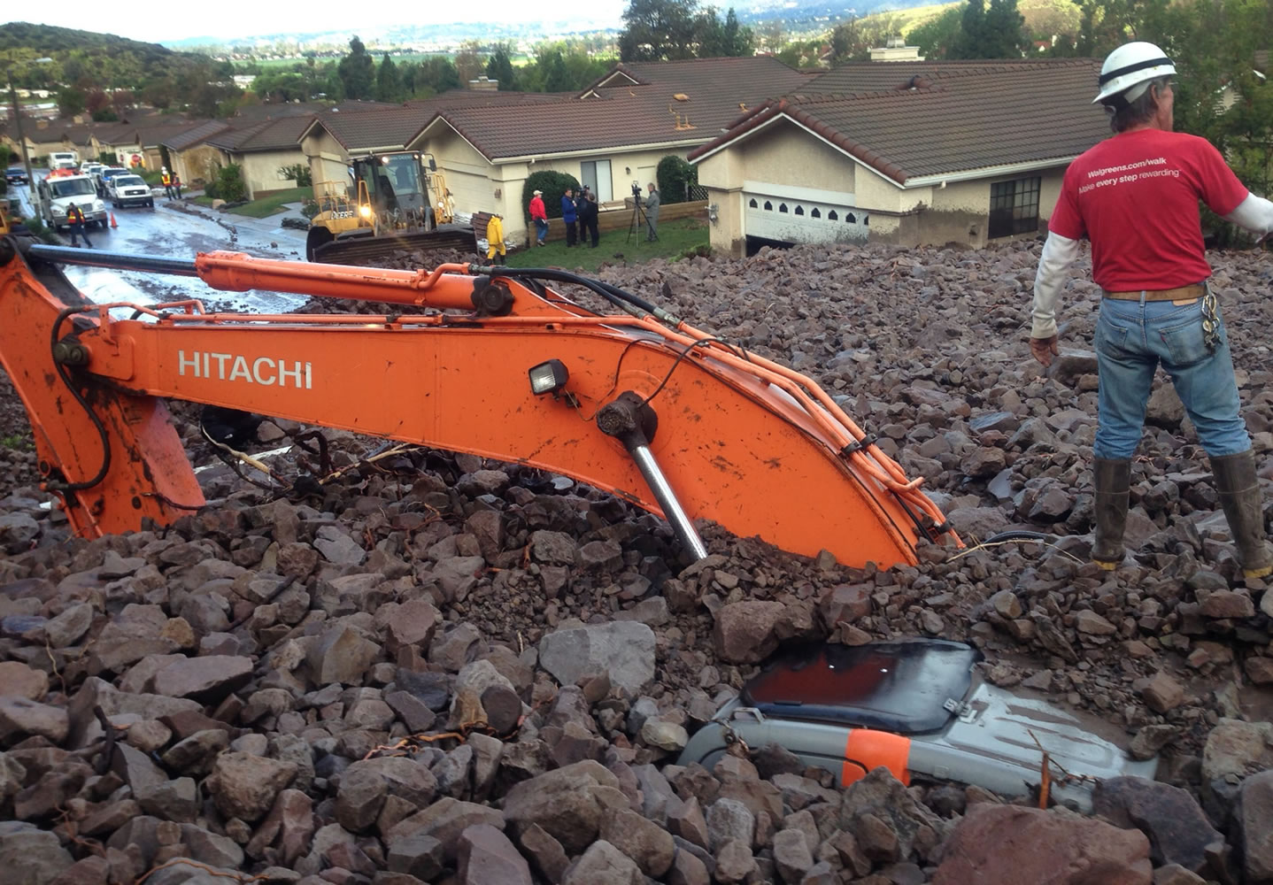 Earth-moving equipment is buried by a debris flow Friday in Camarillo Springs, Calif., about 50 miles northwest of Los Angeles. A soaking storm swept into Southern California, causing several mudslides, flooding streets and cutting power to tens of thousands Friday after lashing the rest of the state with much-needed rain.