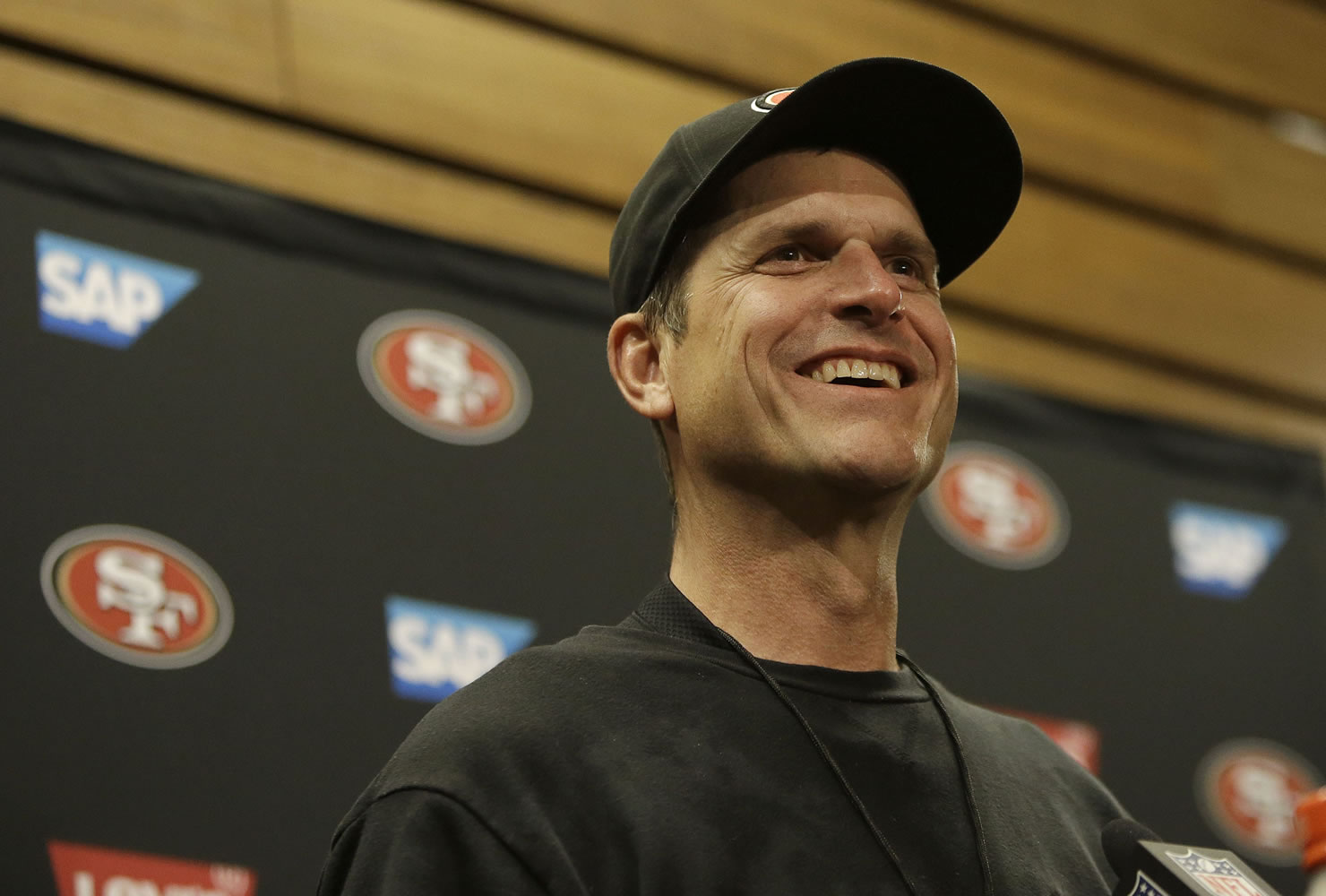 San Francisco 49ers head coach Jim Harbaugh speaks at a news conference after following Sunday's game against the Arizona Cardinals in Santa Clara, Calif., Sunday, Dec. 28, 2014.