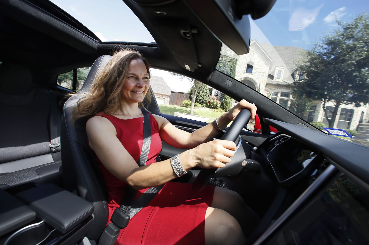 Elizabeth Farrell Peters drives her leather-free Tesla Model S, in Hurst, Texas. For car buyers like Peters and her husband Mark, who have been vegans for more than two decades, leather-free choices are limited. The car-buying site Edmunds.com says 78 percent of 2015 model-year vehicles have standard leather seats on at least one trim level.