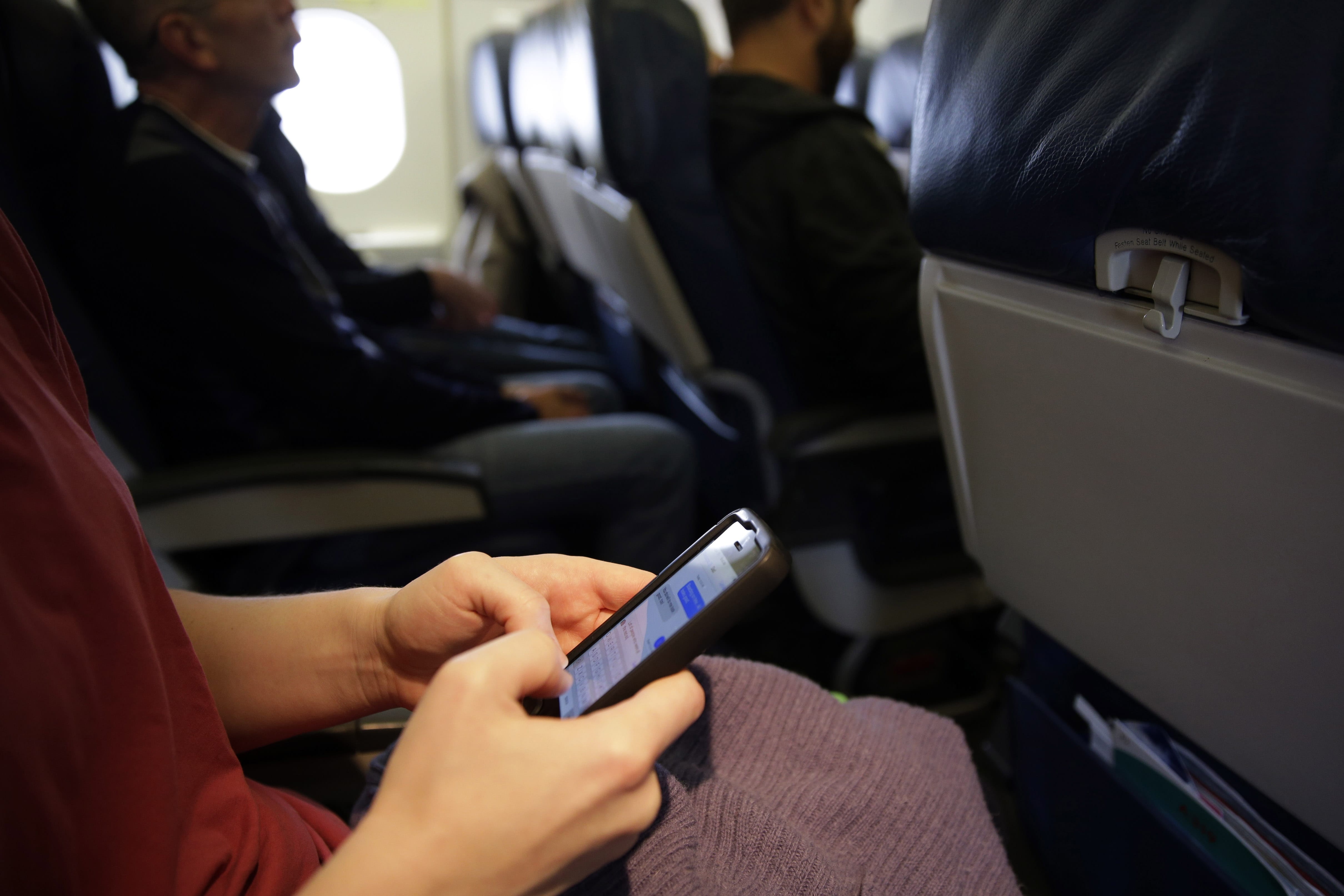 While one government agency considers allowing cellphone calls on passenger planes, another now wants to ban them.