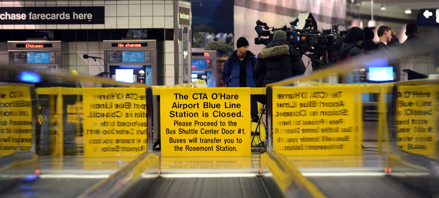 Signs alert travelers to the closing of the Blue Line train station Tuesday at O'Hare International Airport in Chicago after Monday's crash of a commuter train.