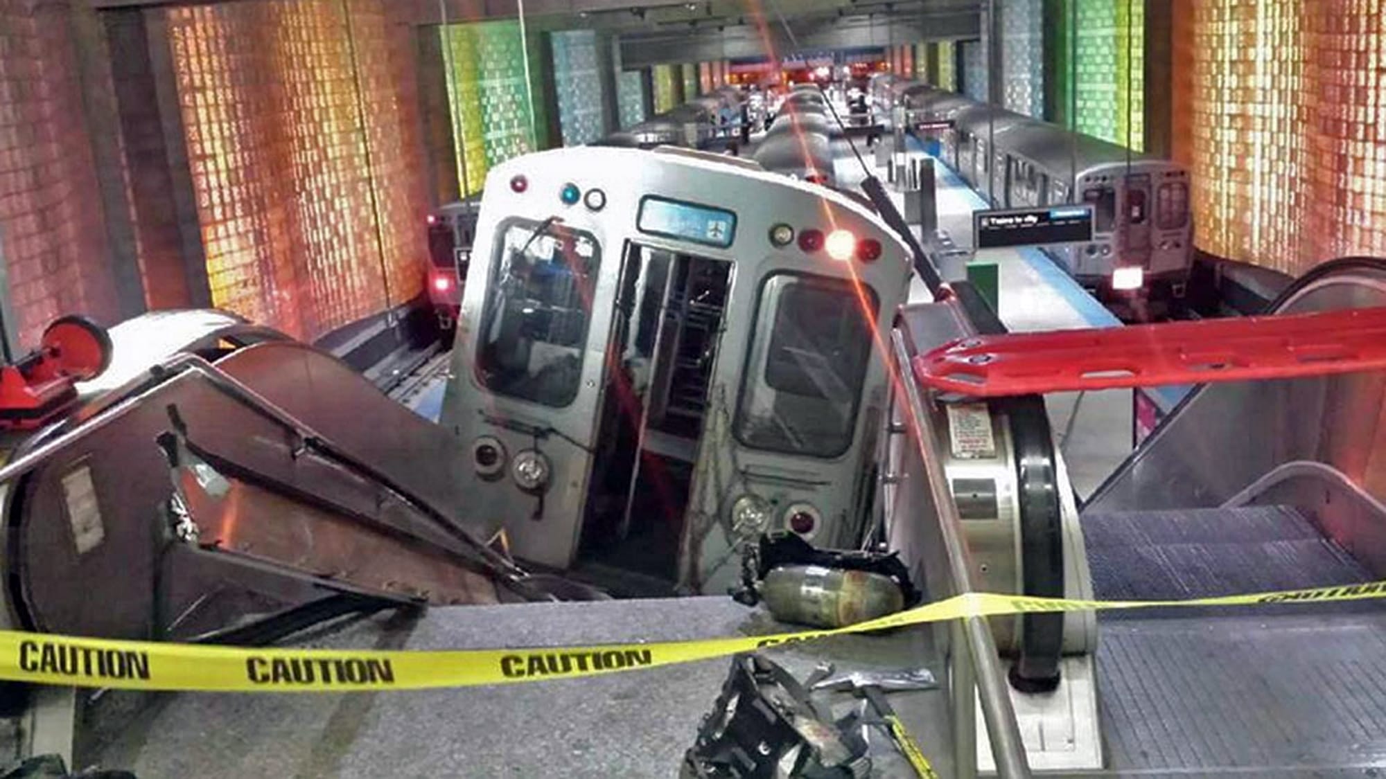 A Chicago Transit Authority train car rests on an escalator at the O'Hare Airport station after it derailed early Monday  injuring more than 30 people in Chicago.