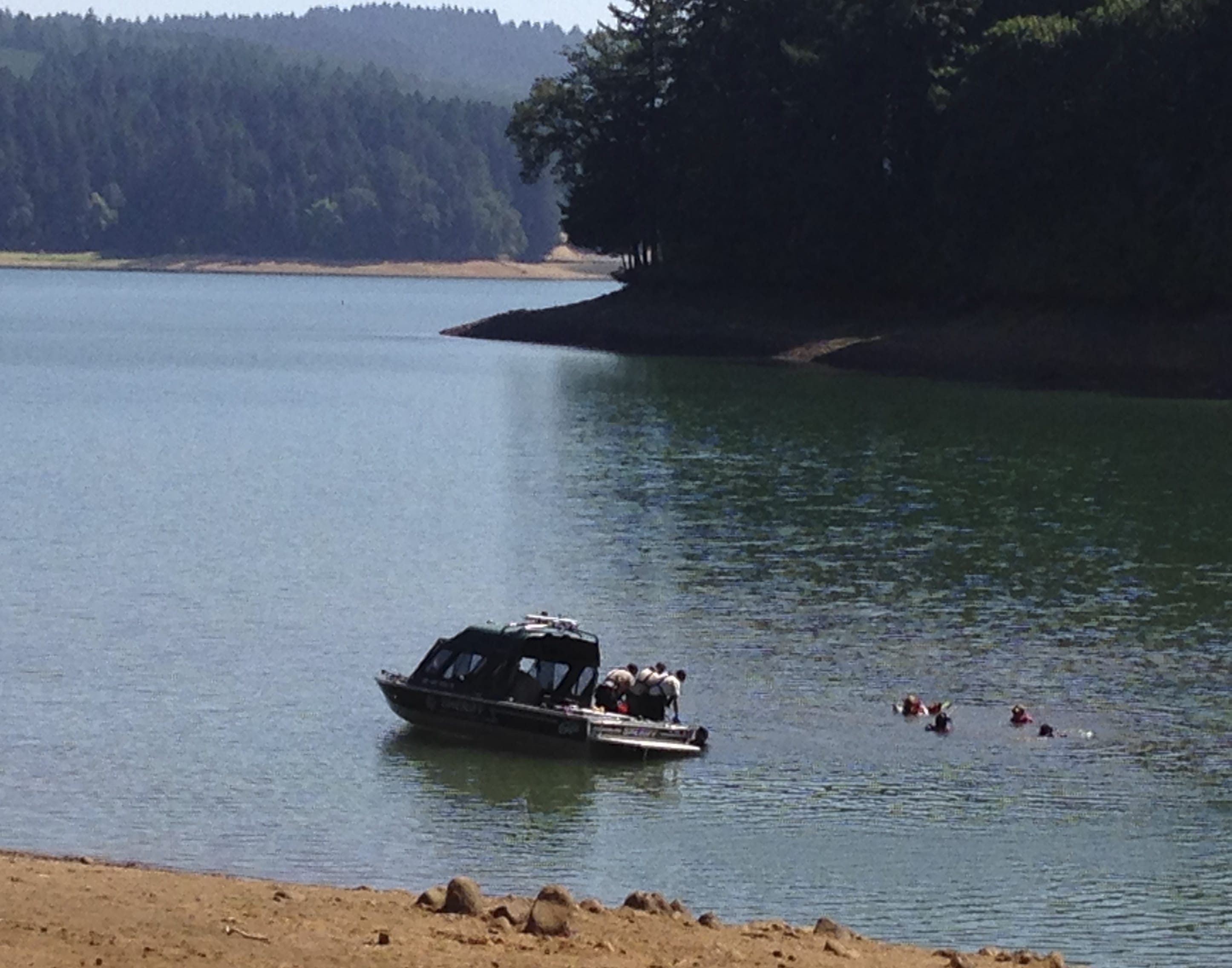 Rescue personnel search Henry Hagg Lake, a reservoir in Gaston, Ore., west of Portland on Tuesday for family members of a child who apparently drowned Monday at the lake.