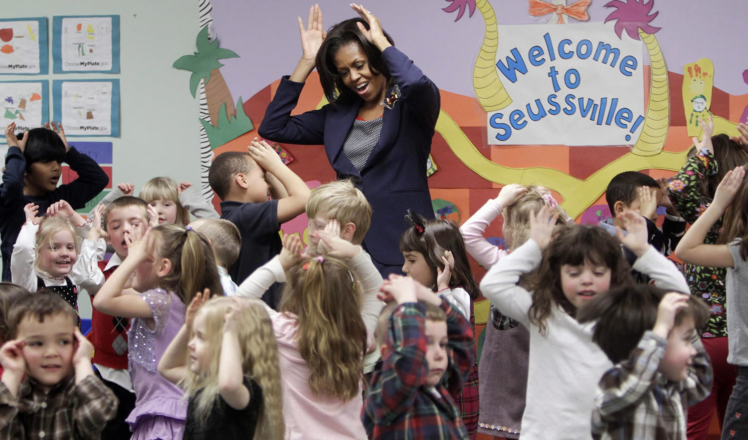 First lady Michelle Obama does a bunny-hop dance with pre-schoolers at the Penacook Community Center in Concord, N.H., in 2012 as part of her Let's Move initiative.