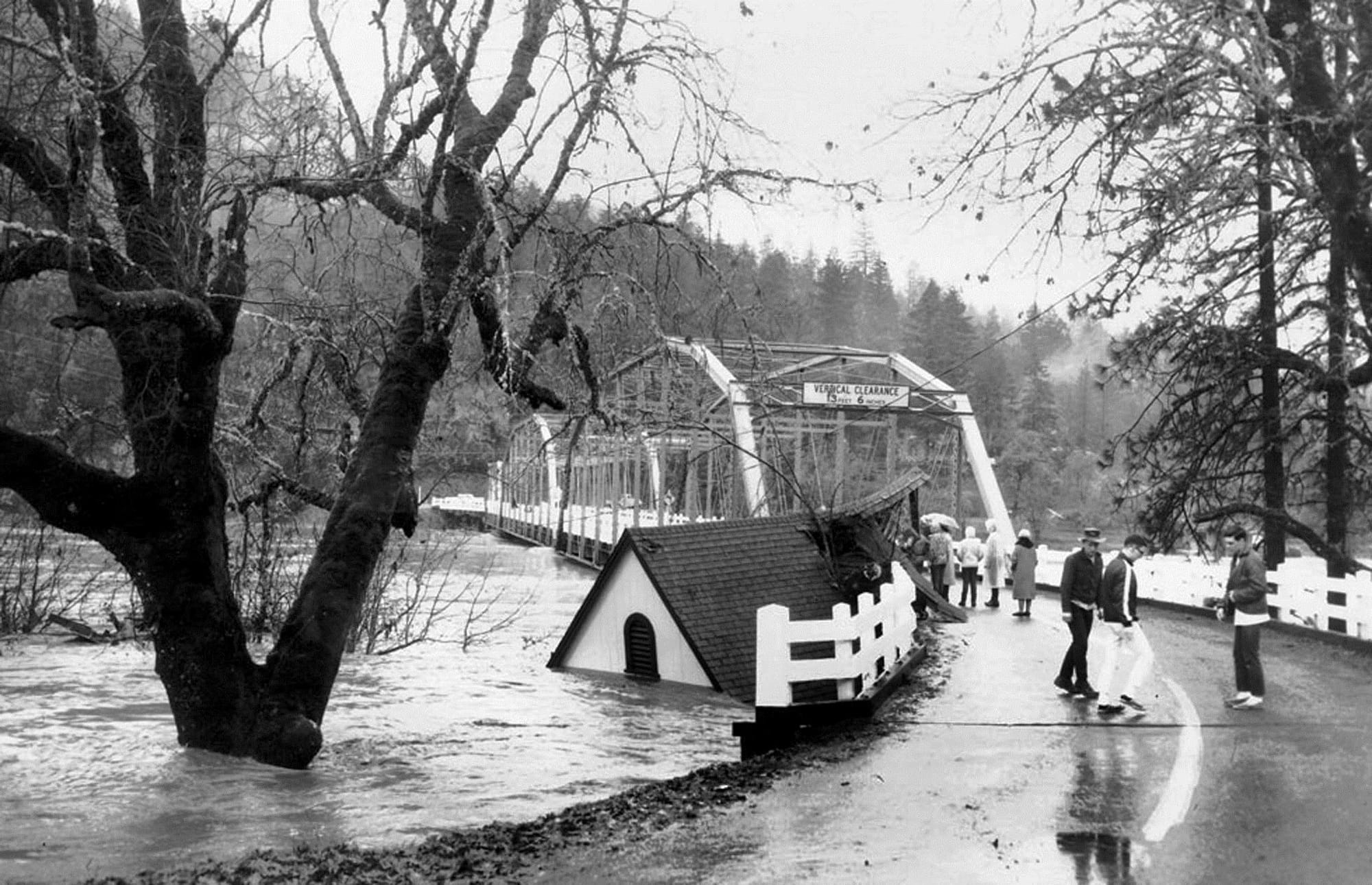 A house floats up against Robertson Bridge in December 1964 downstream of Grants Pass, Ore.