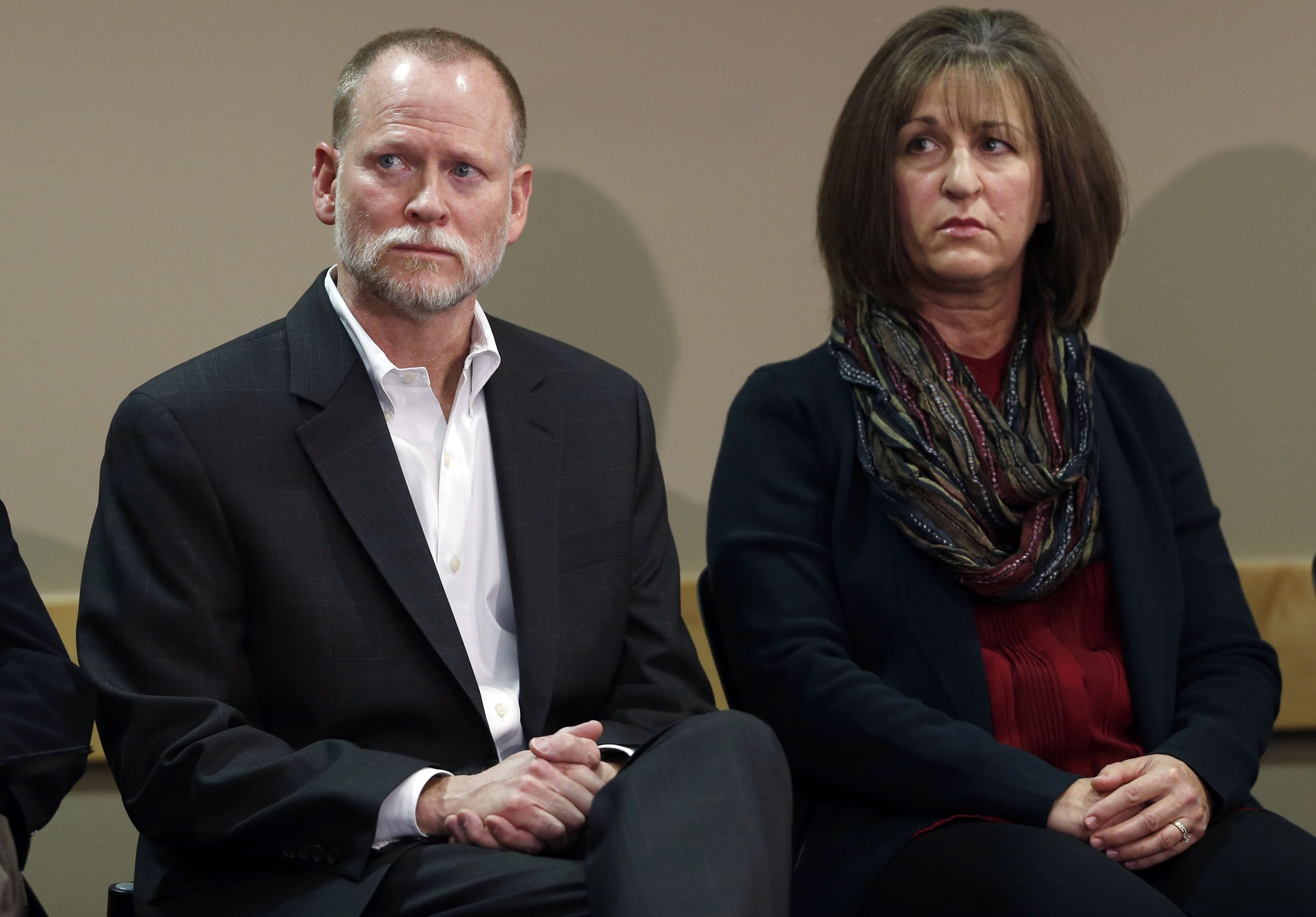 FILE - In this Oct. 10, 2014, file photo, Michael Davis, left, and his wife, Desiree, who lost their daughter Claire Davis in a shooting at Arapahoe High School last December, listen to an investigation into a deadly shooting at the school during a news conference in the sheriff's office in Centennial, Colo. The father of a student who killed Claire Davis before committing suicide posted a newspaper obituary for his son on the first anniversary of the shooting. The Saturday, Dec. 13, 2014 obit came the same day a candlelight vigil will be held for Davis. Mark Pierson said he didn't mean to disrespect the Davis family but wants his son, Karl, remembered as a good son who lost his way for a moment.