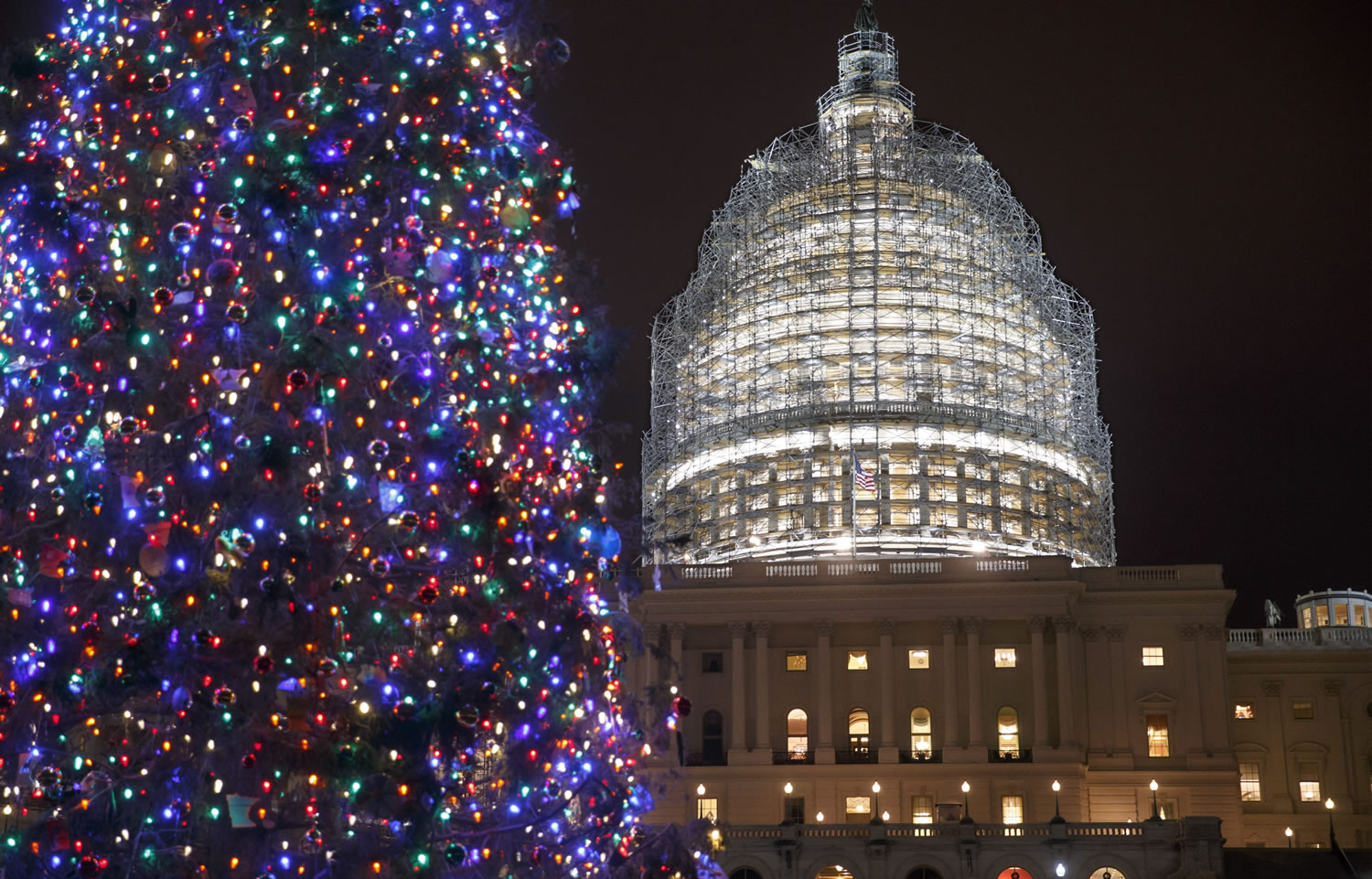 The Capitol Dome and the Capitol Christmas Tree are illuminated late Thursday evening as Congress works to pass a $1.1 trillion U.S. government-wide spending bill and avoid a government shutdown, in Washington.