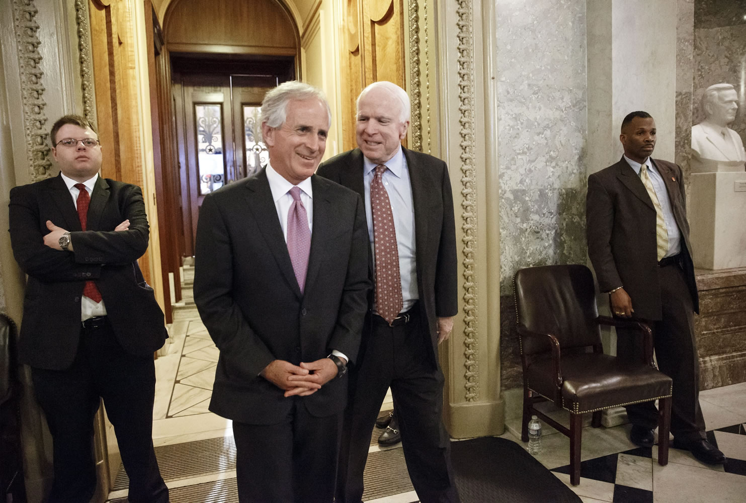 Sen. Bob Corker, R-Tenn., left, and Sen. John McCain, R-Ariz., join other lawmakers Monday during the vote on restoring jobless benefits for the long-term unemployed, legislation that expired late last year, at the Capitol in Washington.