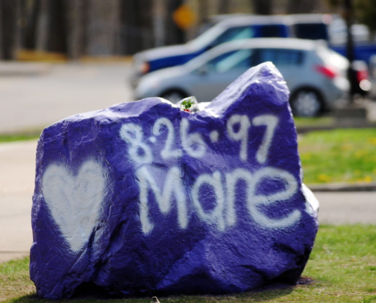 A rock spray-painted by students sits in memory of 16-year-old stabbing victim Maren Sanchez on Friday sits outside Jonathan Law High School in Milford, Conn.