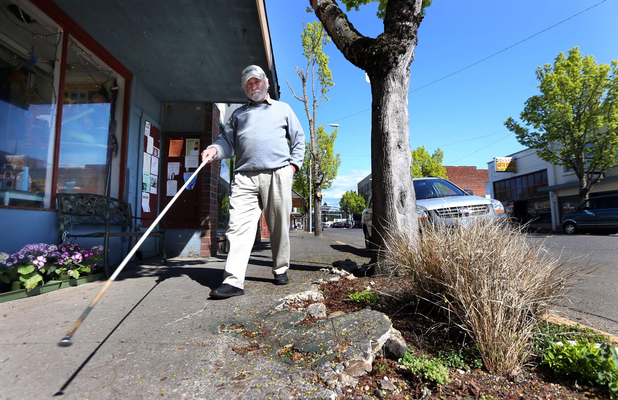 Jim Kness, who has been blind for most of his adult life, navigates his way down Main Street on April 9 in Cottage Grove, Ore.