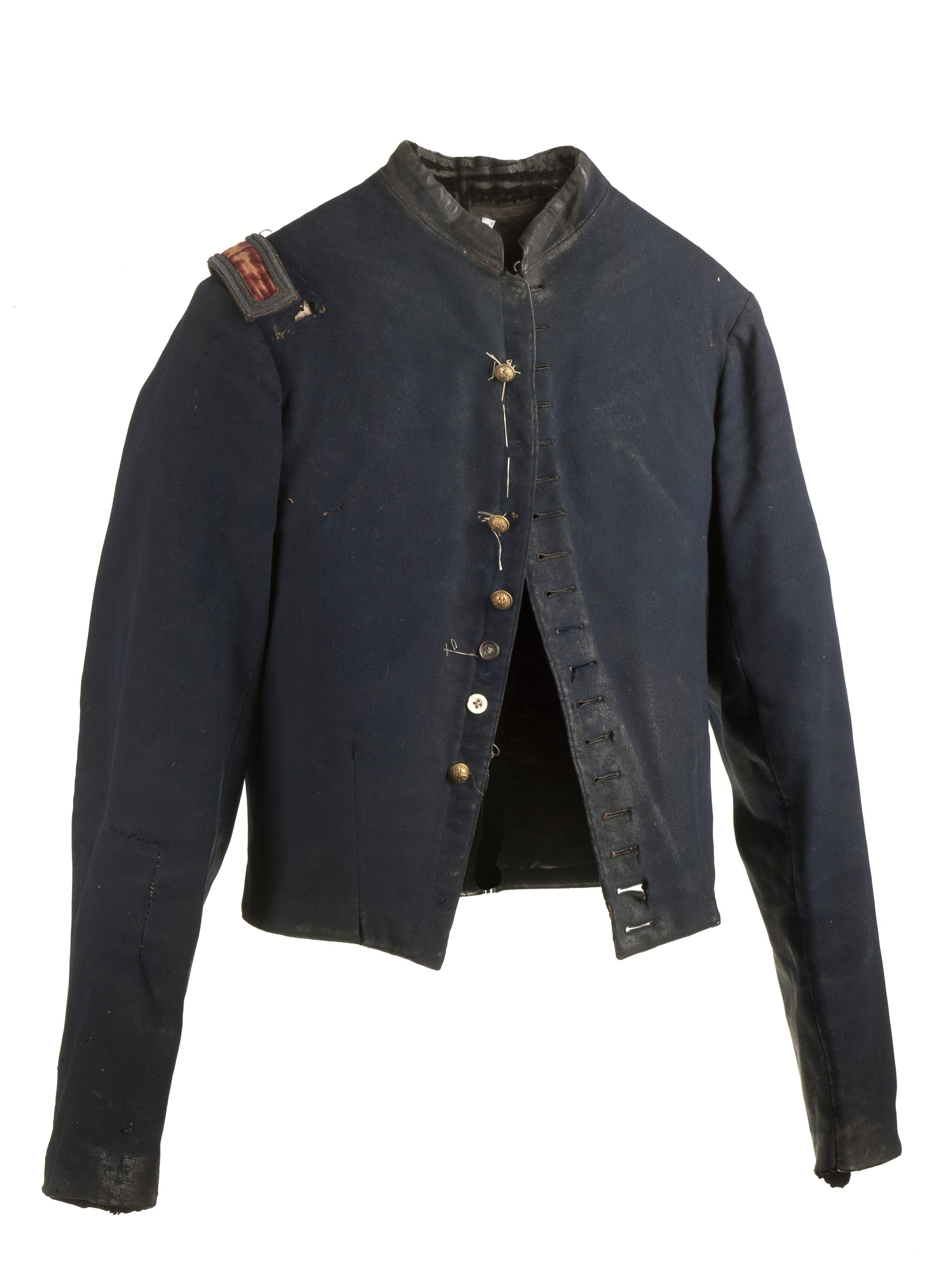 New-York Historical Society
This photo provided by the New-York Historical Society shows a torn and stained field jacket worn by William Henry Shelton, a New York officer, who was captured on May 5, 1864, and wore the jacket during his 10 months of imprisonment and multiple escapes in Georgia and South Carolina. The jacket has been preserved in the same condition it was in at the end of the war, coated in grime and missing many of its brass buttons. A hard-hitting exhibit of quilts, clothing, uniforms and other Civil War era textiles, brings new life and depth to a complicated and heart-wrenching time, in iHomefront and Battlefield: Quilts and Context in the Civil War,i a traveling exhibit on view in New York through August 24, 2014.