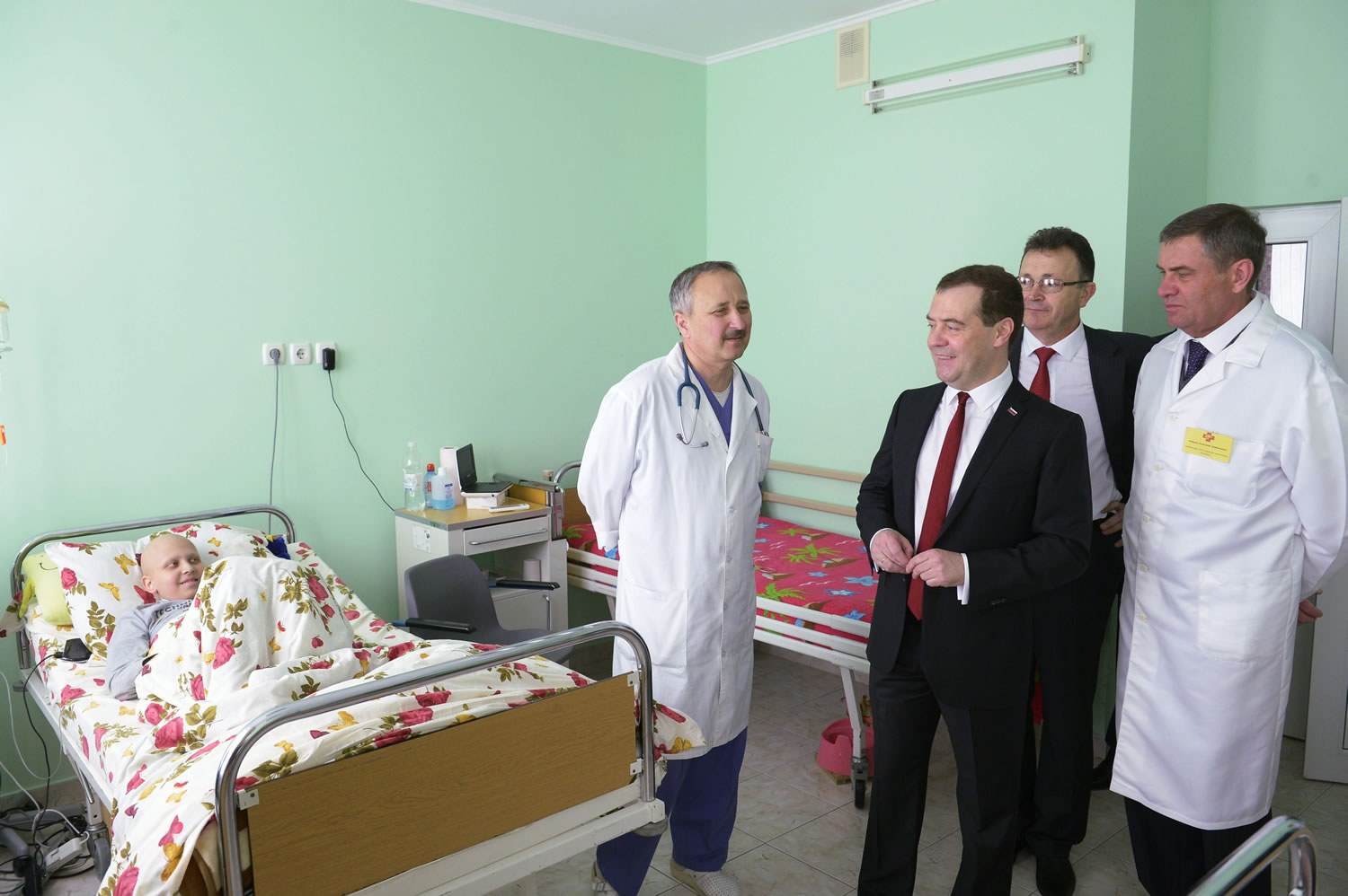Russian Prime Minister Dmitry Medvedev, third right, smiles while visiting a city children's hospital in Simferopol, Crimea, on Monday.