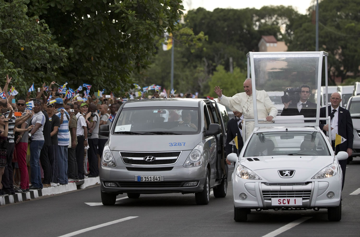 Pope Francis waves to people from his popemobile as he arrives to the Apostolic Nunciature in Havana, Cuba, Saturday, Sept. 19, 2015. Pope Francis began a 10-day trip to Cuba and the United States, embarking on his first trip to the onetime Cold War foes after helping to nudge forward their historic rapprochement.