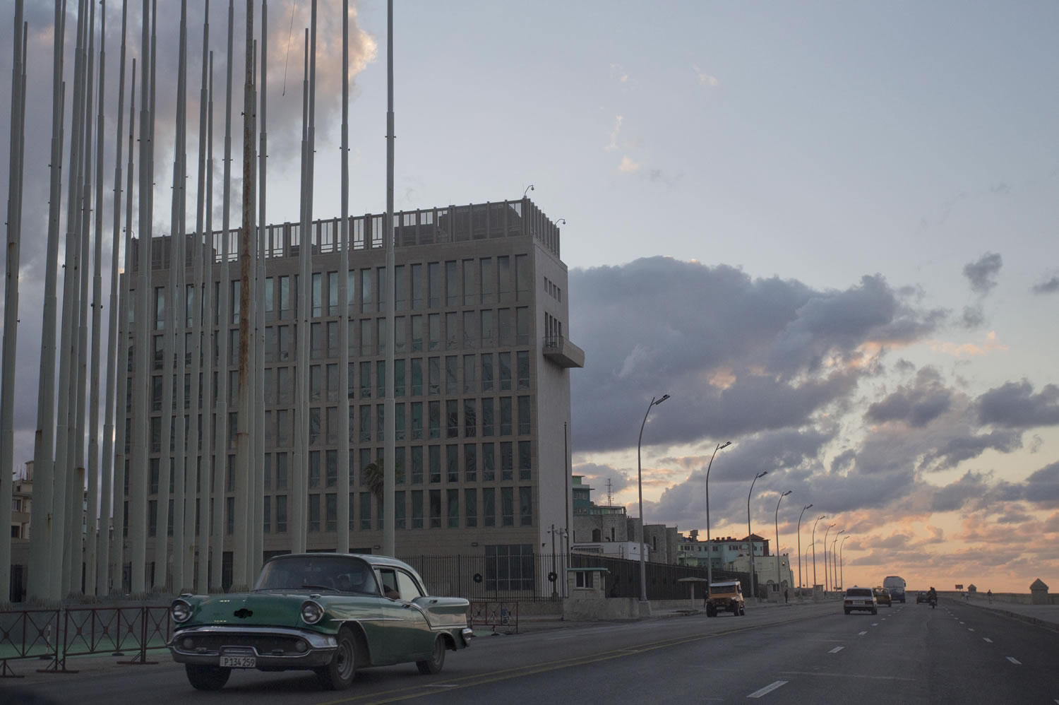 A classic American car drives past the U.S. Interests Section building on Dec.