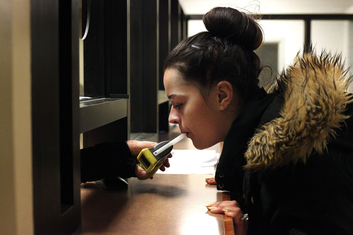 Autumn Regimbal, 19, blows into a Breathalyzer on Sept. 21 in the wing of the county jail dedicated to the state&#039;s 24/7 Sobriety Program in Sioux Falls, S.D.