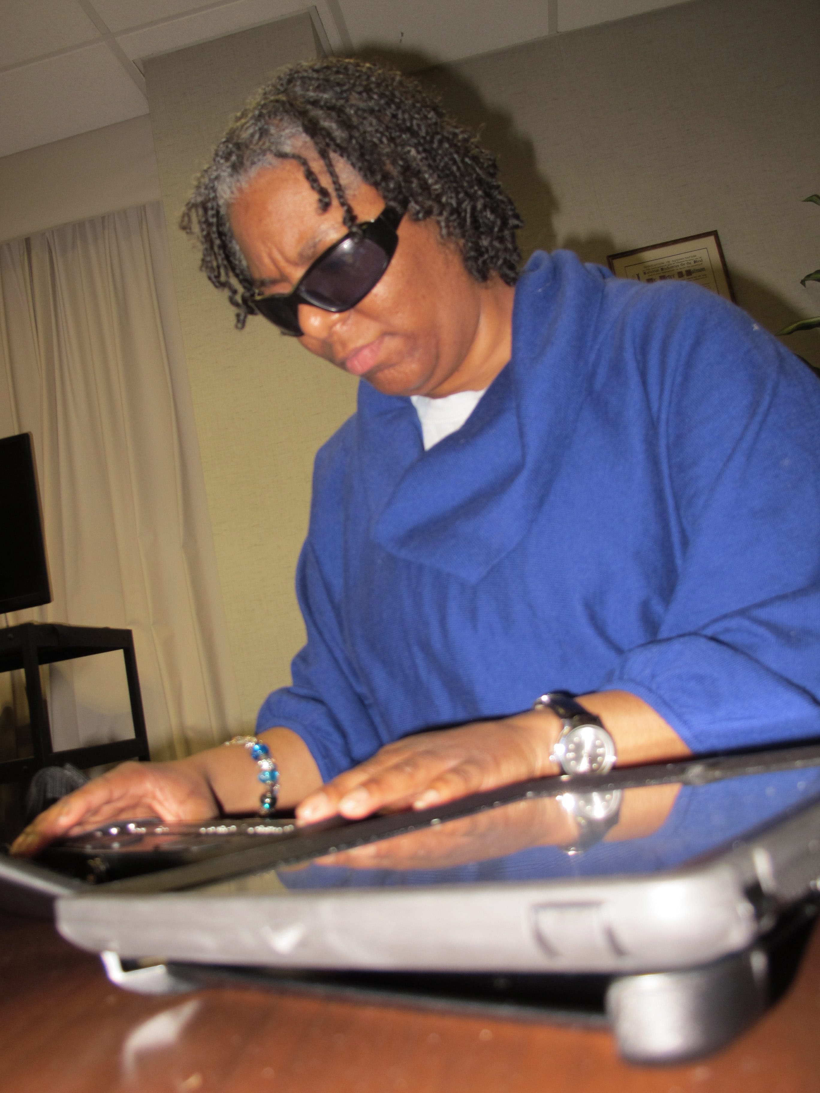 Tanisha Verdejo, a client at the Helen Keller National Center, demonstrates the use of a specially designed keyboard that helps blind clients access the Internet, in Sands Point, N.Y.