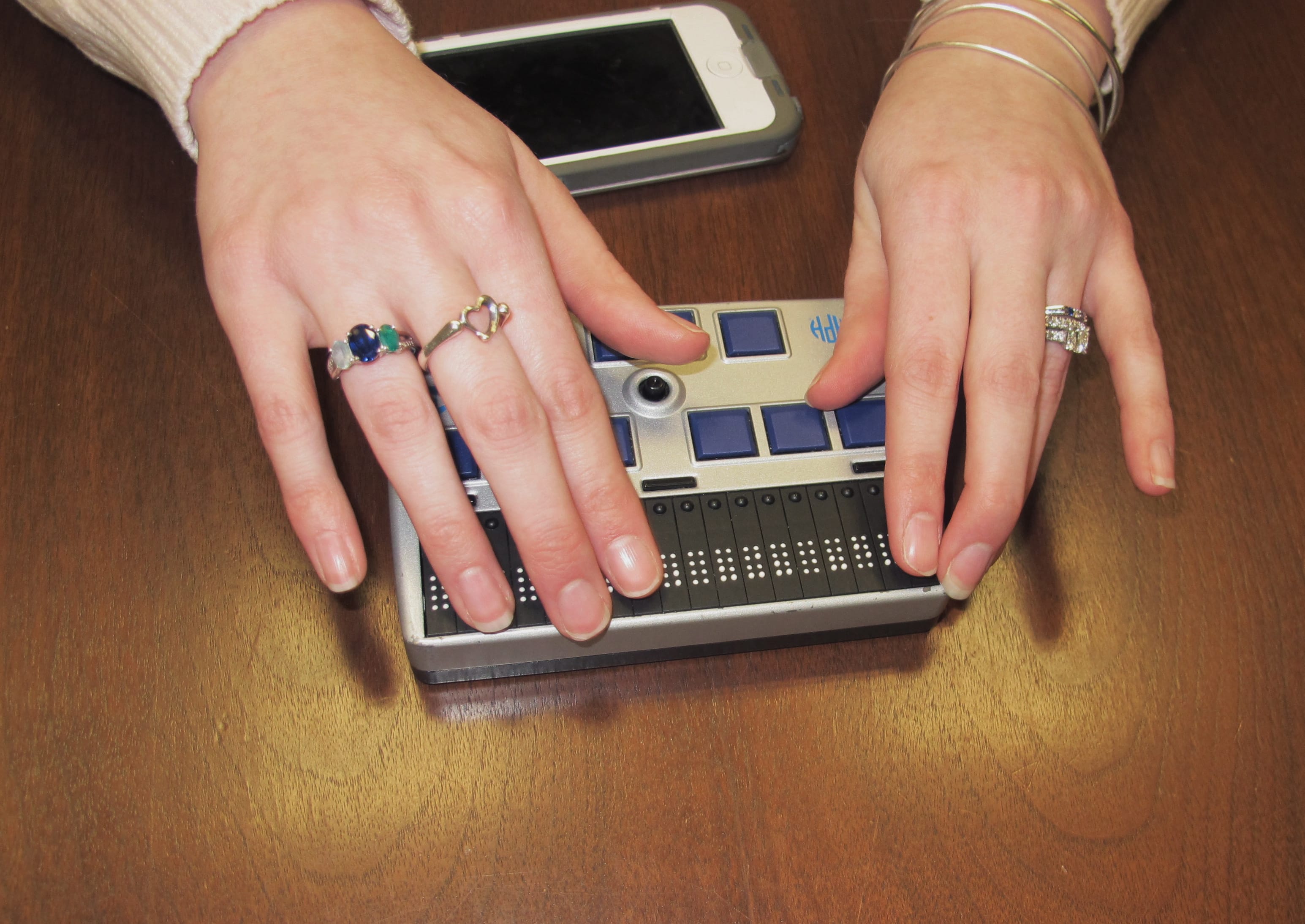 Megan Dausch, an instructor at the Helen Keller National Center, demonstrates the use of a Braille reader that helps blind clients access the Internet, in Sands Point, N.Y.