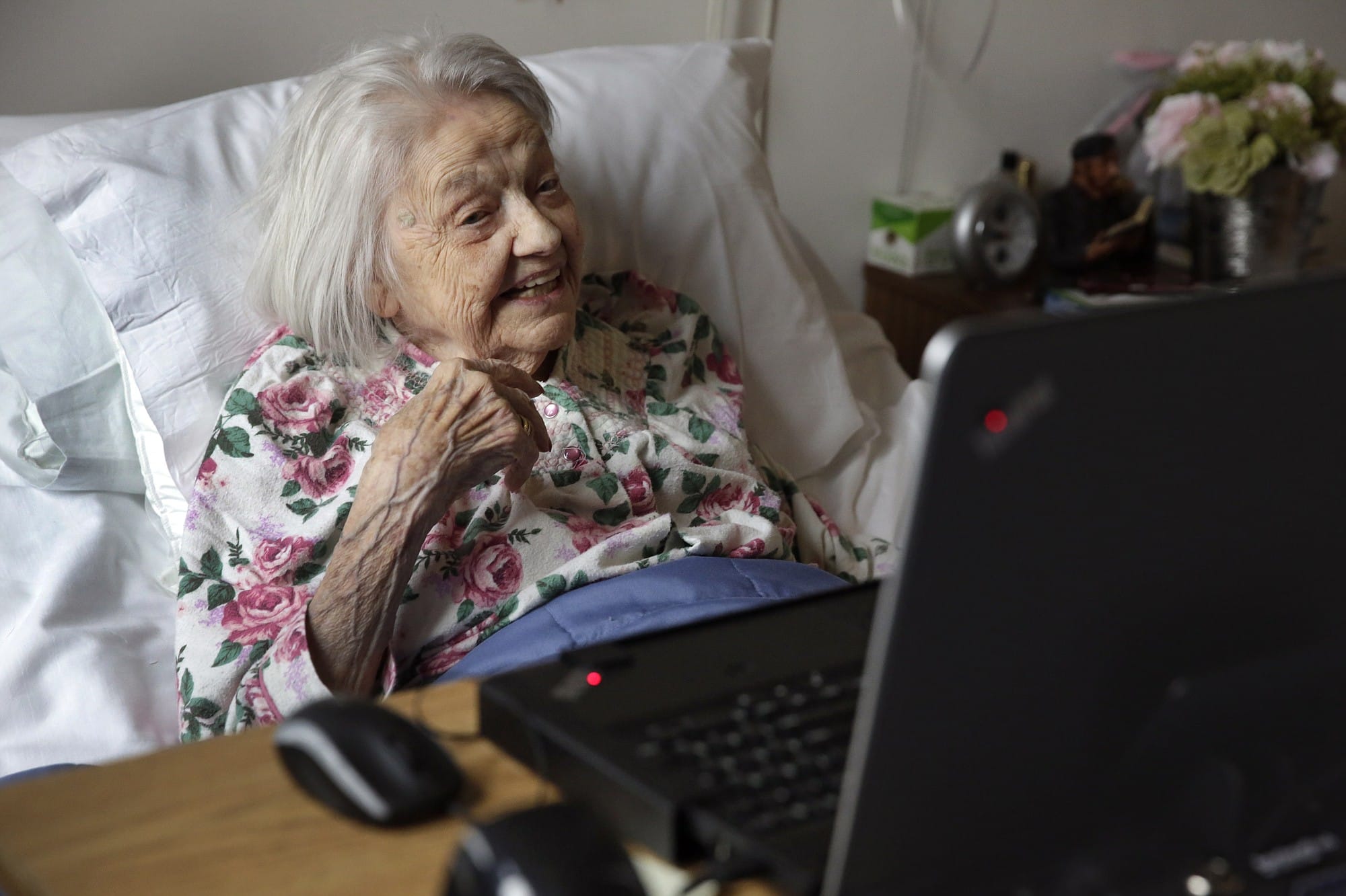Dementia patient Louise Irving watches a laptop computer with her daughter's morning wake-up video message last month at The Hebrew Home at Riverdale in New York.