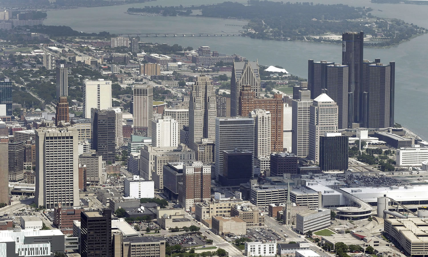 In this July 16, 2013 aerial file photo, the downtown of the city of Detroit is shown. Detroit Emergency Manager Kevyn Orr raised more than a few eyebrows a year ago when he took the city into bankruptcy and predicted it would be out by the time his term expired in fall 2014. Because it is by far the largest city to file for municipal bankruptcy and the issues were so complex many experts predicted it would take years to resolve. But the city will take a major step toward that goal with a trial in federal bankruptcy court that starts Tuesday, Sept 2, 2014.