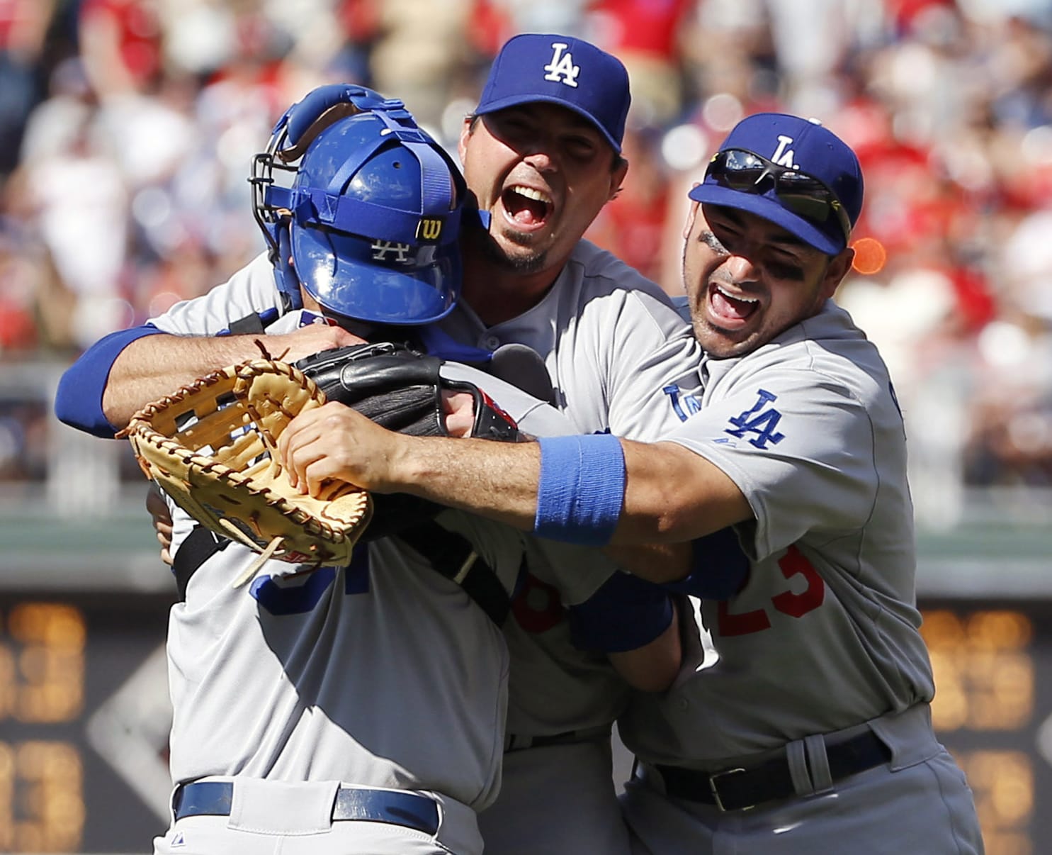 Los Angeles Dodgers starting pitcher Josh Beckett, center, celebrates with catcher Drew Butera, left, and first baseman Adrian Gonzalez after pitching a no-hitter against the Philadelphia Phillies, Sunday, May 25, 2014, in Philadelphia. Los Angeles won 6-0. Beckett pitched the first no-hitter of his career and the first in the majors this season.