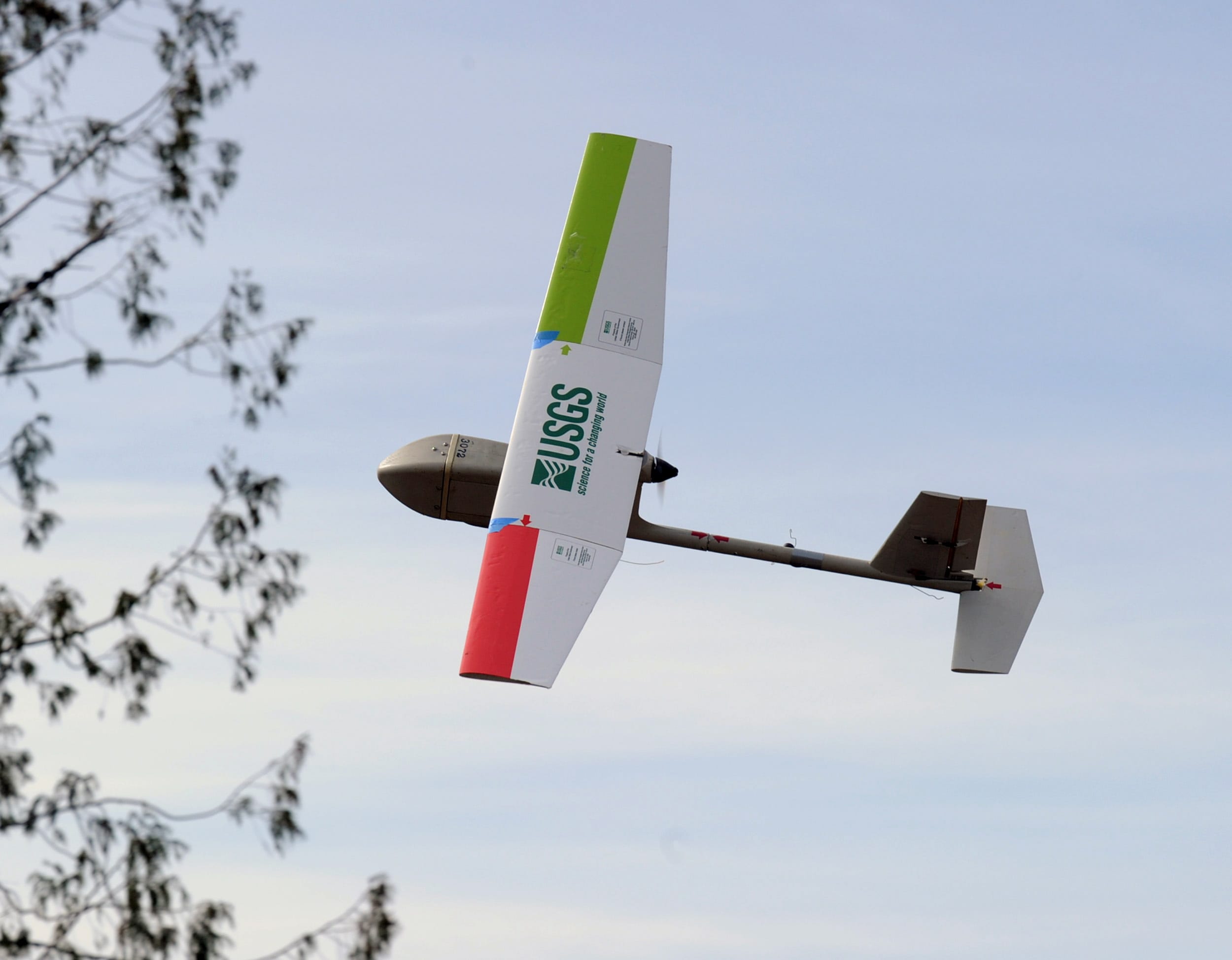 A 4-pound, battery-powered aircraft flies over a ridge above the Skagit Valley near Hamilton.