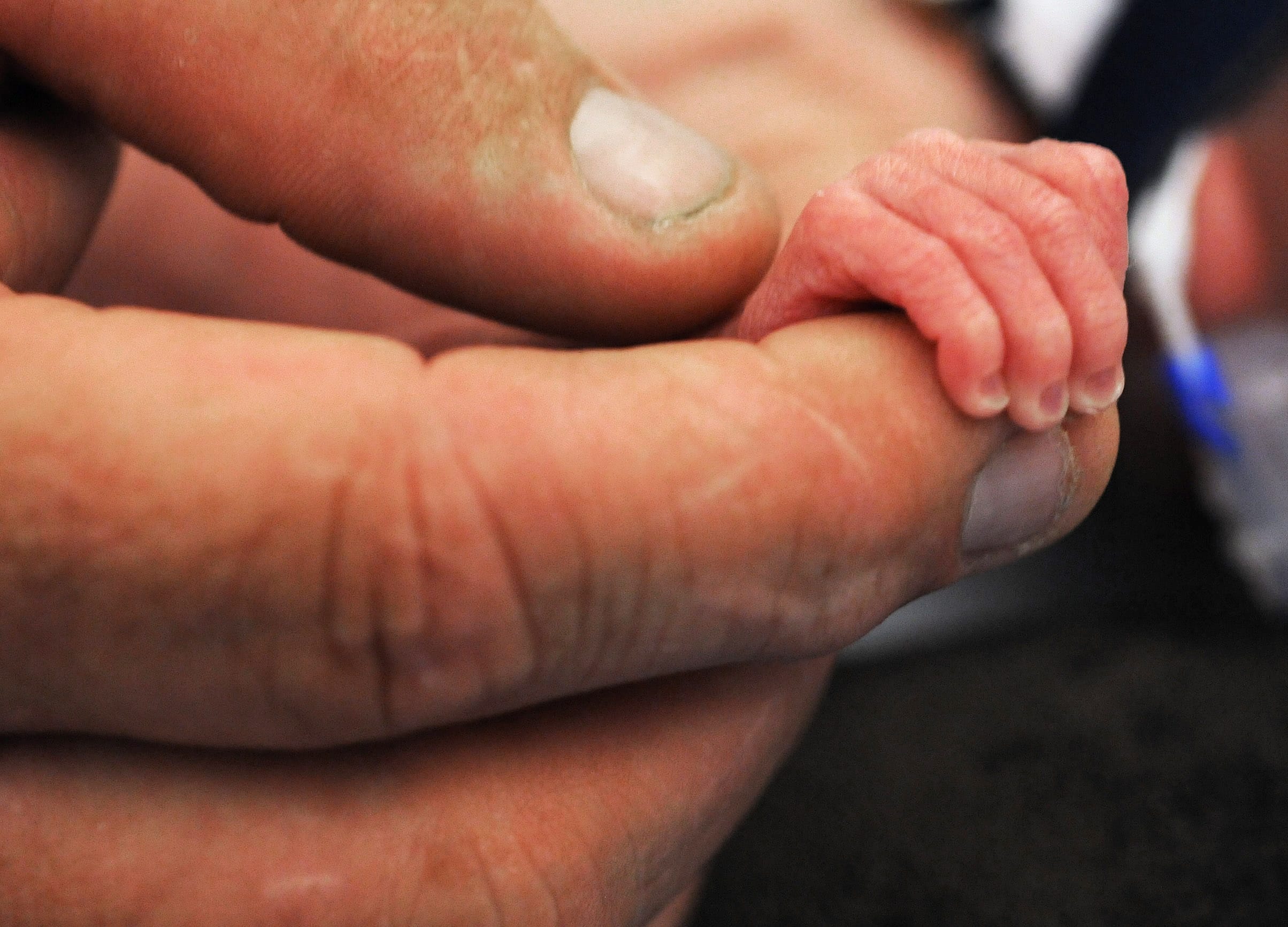 A father holds the hand of his prematurely born son in the neonatal intensive care unit at the Betty H. Cameron Women's &amp; Children's Hospital in Wilmington, N.C.