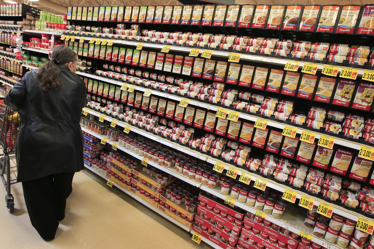 A shopper walks down the canned-soup aisle at a grocery store in Cincinnati.