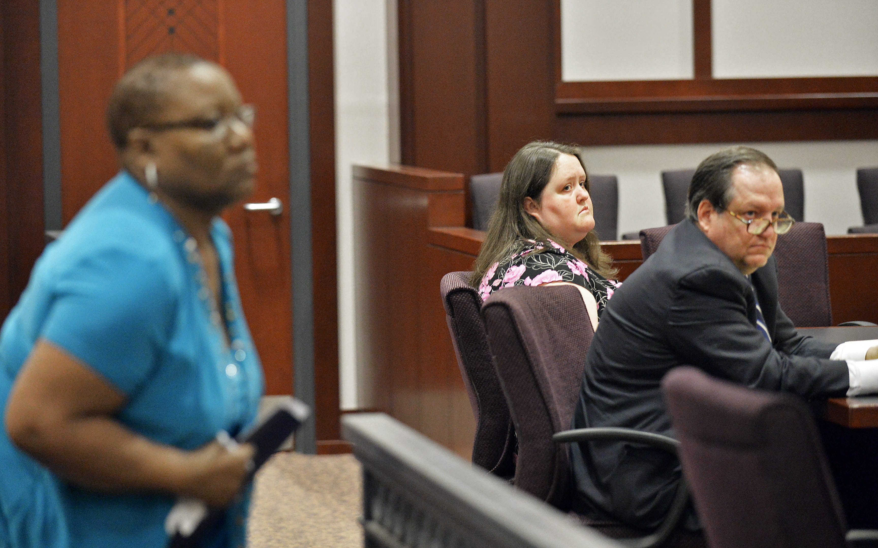 Rachael Michelle Rapraeger, center, sits April 15 with her attorney, Floyd Buford, right, after Sharon Holmes read her statement to a Houston County Superior Court, in Perry, Ga., during a sentencing hearing.