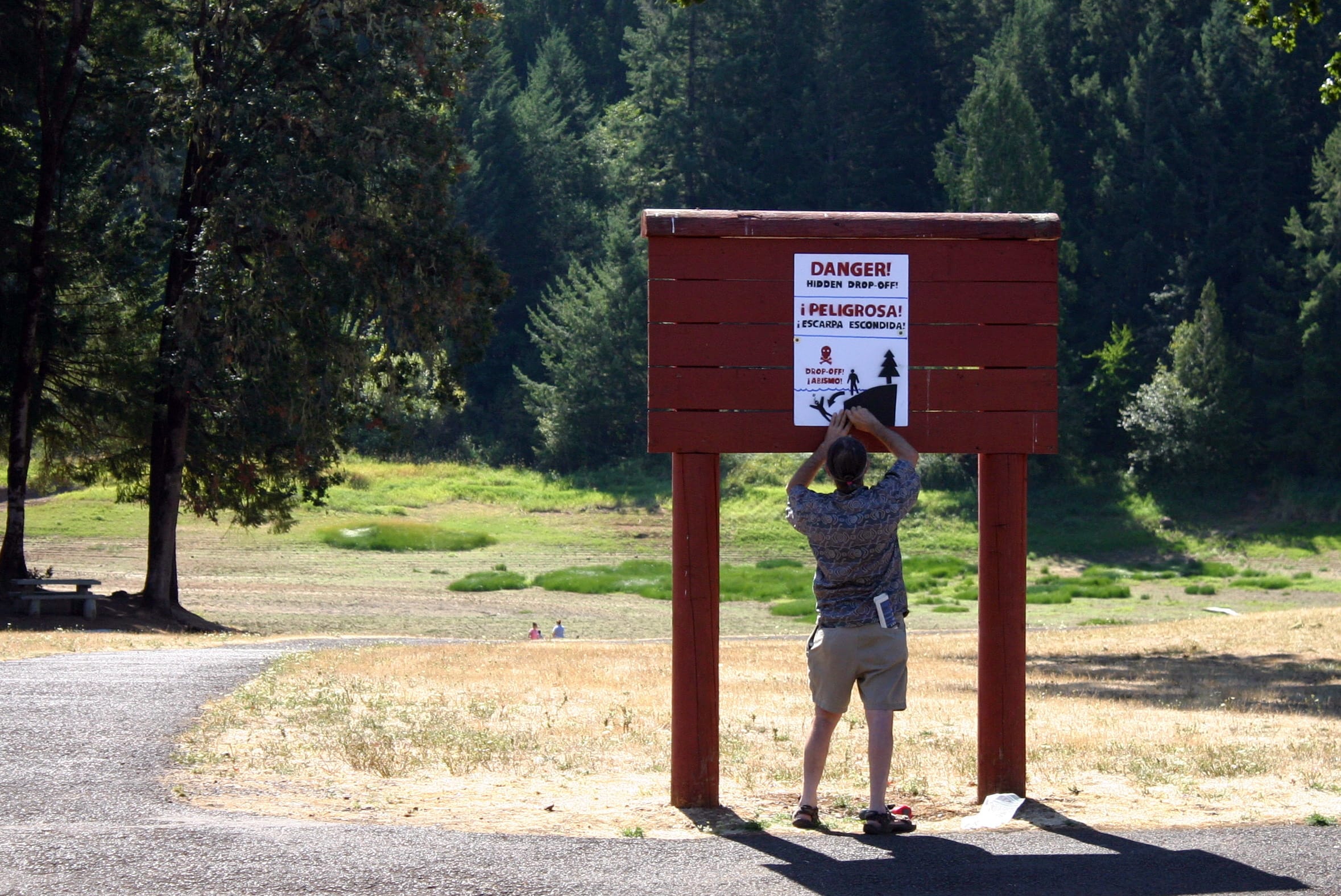 A man Friday posts a warning sign at Hagg Lake, near Gaston, Ore., near where three generations of a Hillsboro, Ore., family drowned last month.