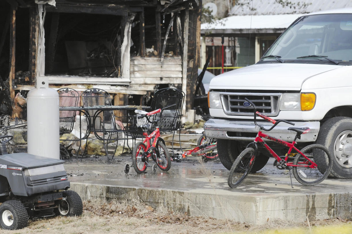 Childrens' bicycles sit in front of remains of home after an early morning fire in Greenville, Ky., on Thursday.