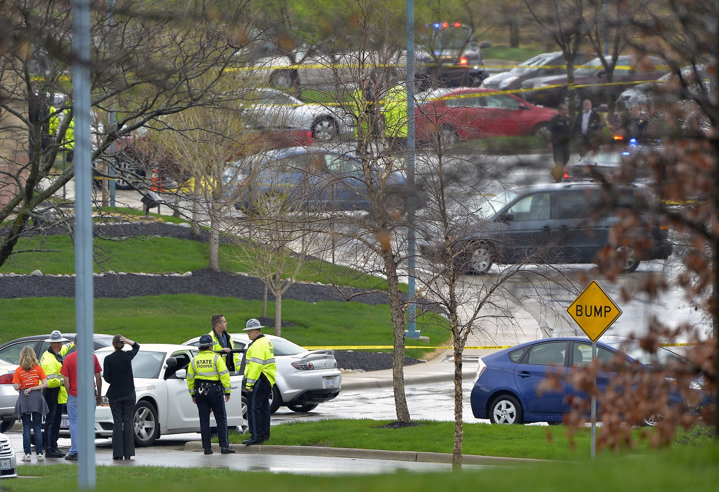 Kansas State Troopers stand near the site of a shooting at the Jewish Community Center in Overland Park, Kan., on Sunday,  Overland Park Fire Department spokesman Jason Rhodes said Sunday afternoon that one person of interest is in custody.