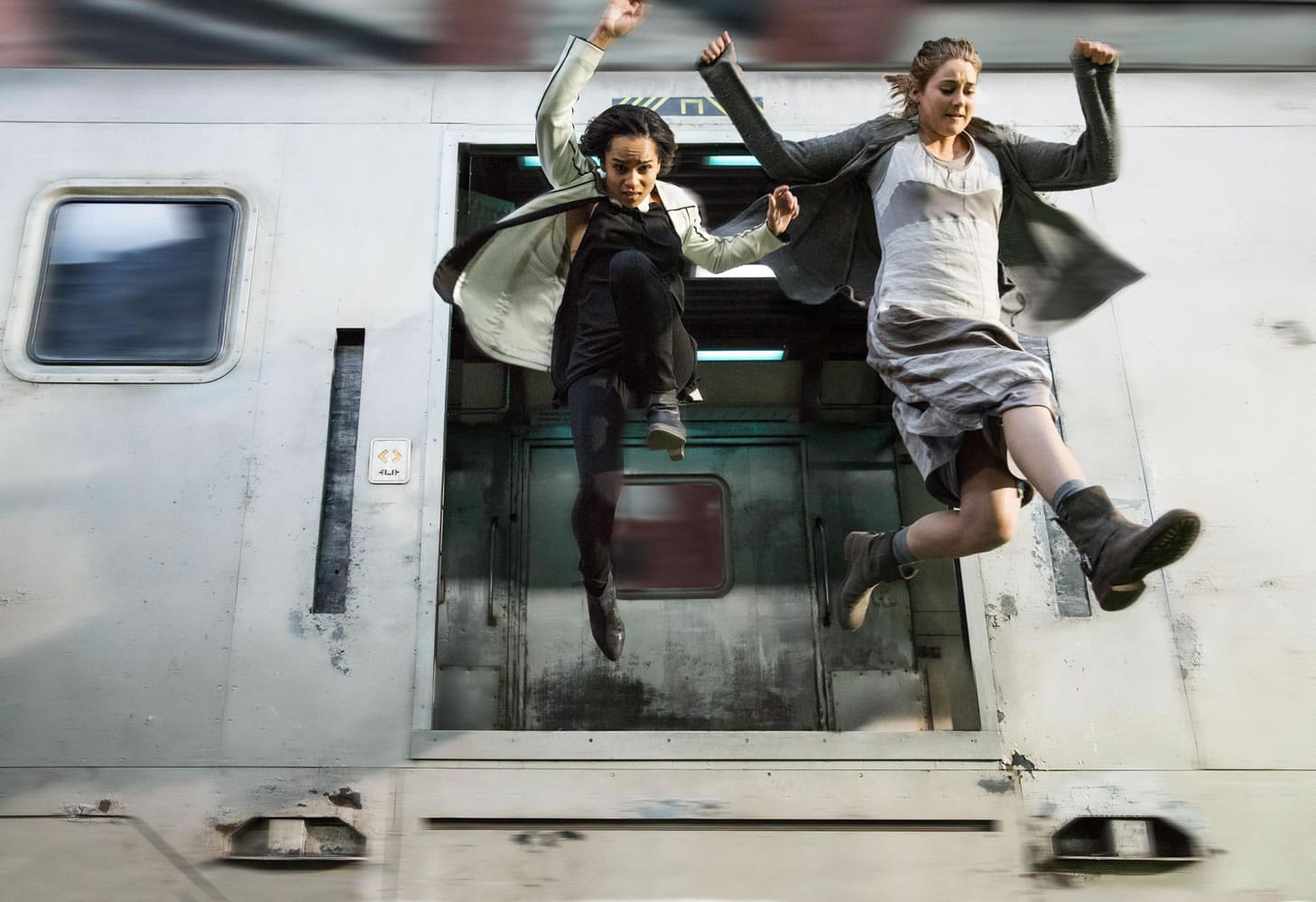 Zoe Kravitz, left, and Shailene Woodley jump from a moving train in &quot;Divergent.&quot;