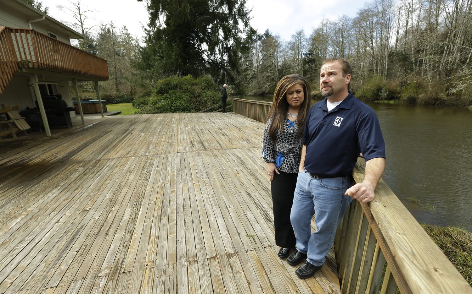 Leonor and Darrin Moir stand March 18 on the deck of the Hoquiam house they bought in 1996 on the Little Hoquiam River. The Moirs pay about $1,700 annually for flood insurance, even though they say they have never had a major flood.
