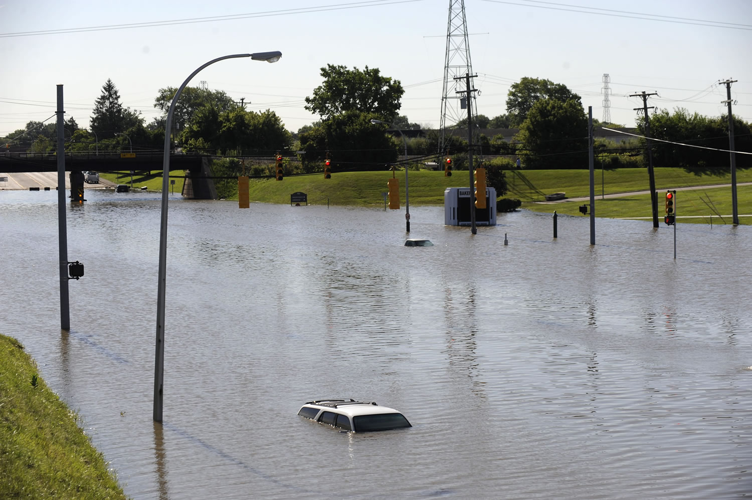 Cars are submerged under flood waters Wednesday in front of Baker College along Outer Drive near Interstate 94 in Allen Park, Mich. Michigan Gov.