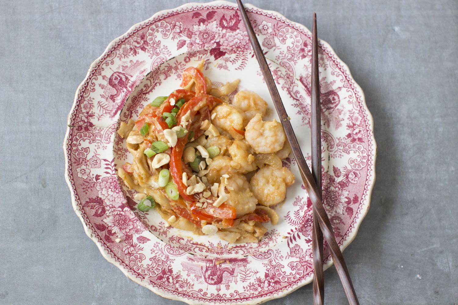 Fried udon noodles with red peppers and shrimp, all slathered in a spicy peanut sauce is simple and filling.