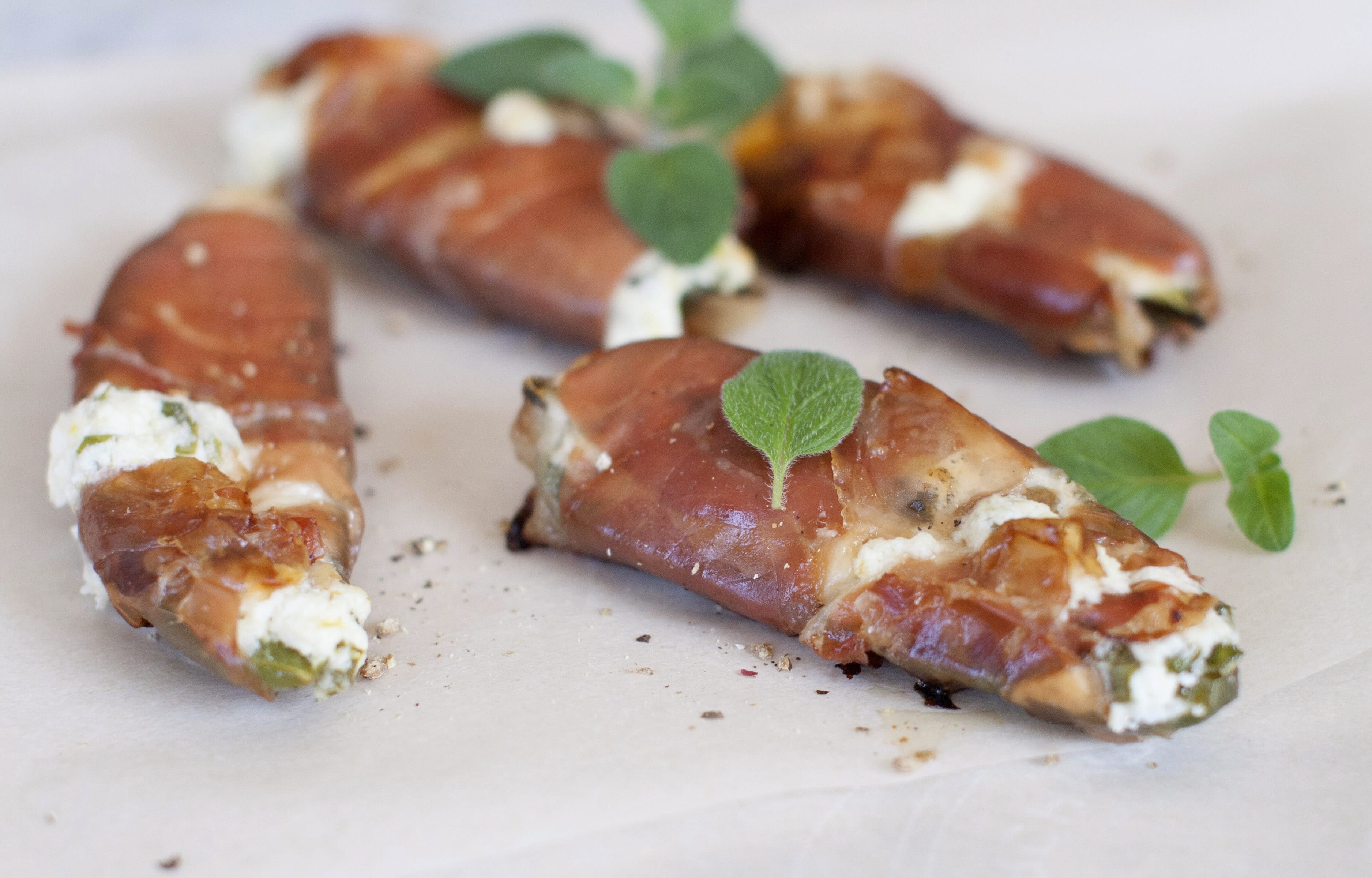 Baked prosciutto-wrapped jalapeno poppers.