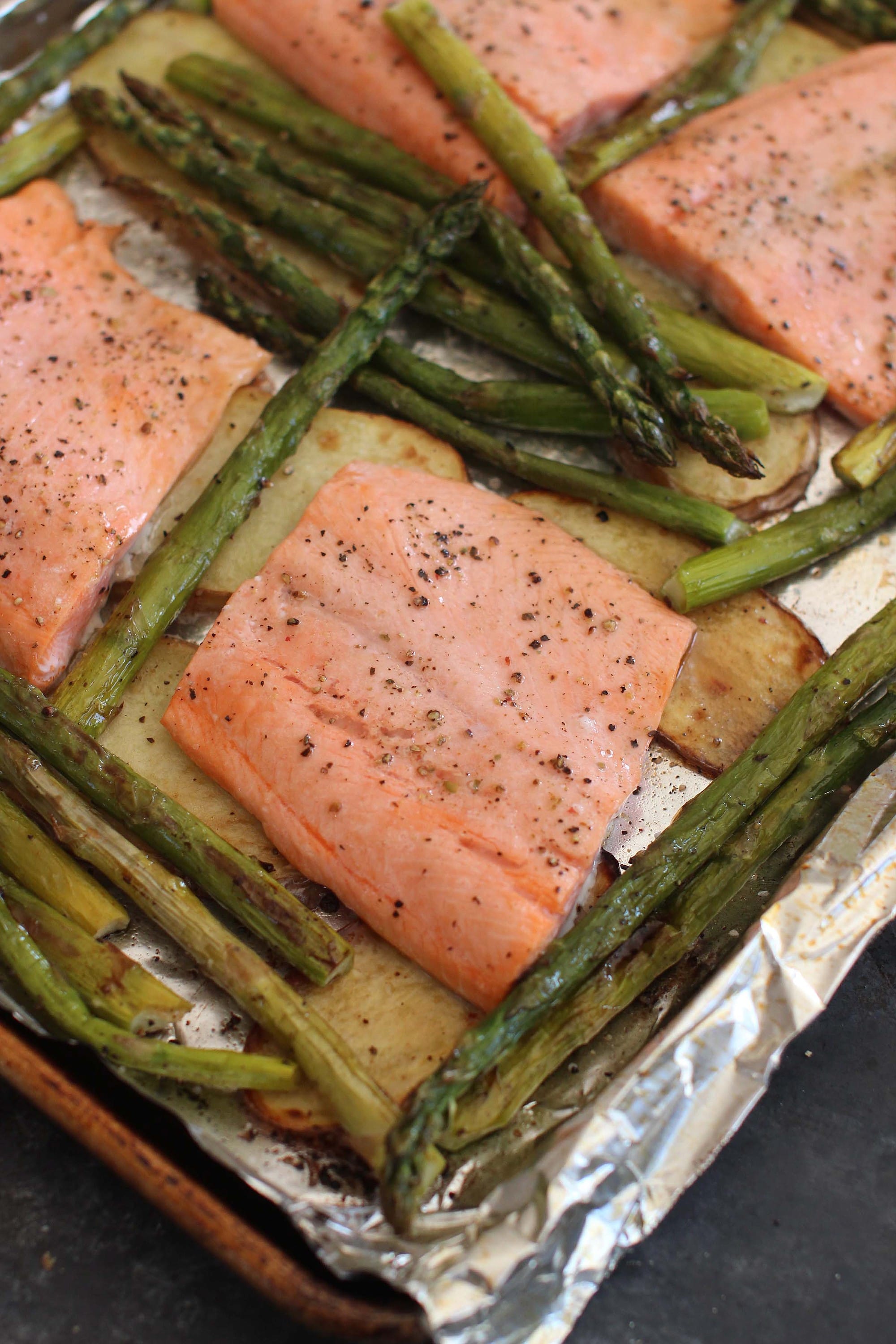 Baked steelhead trout with asparagus, potatoes and herbs
