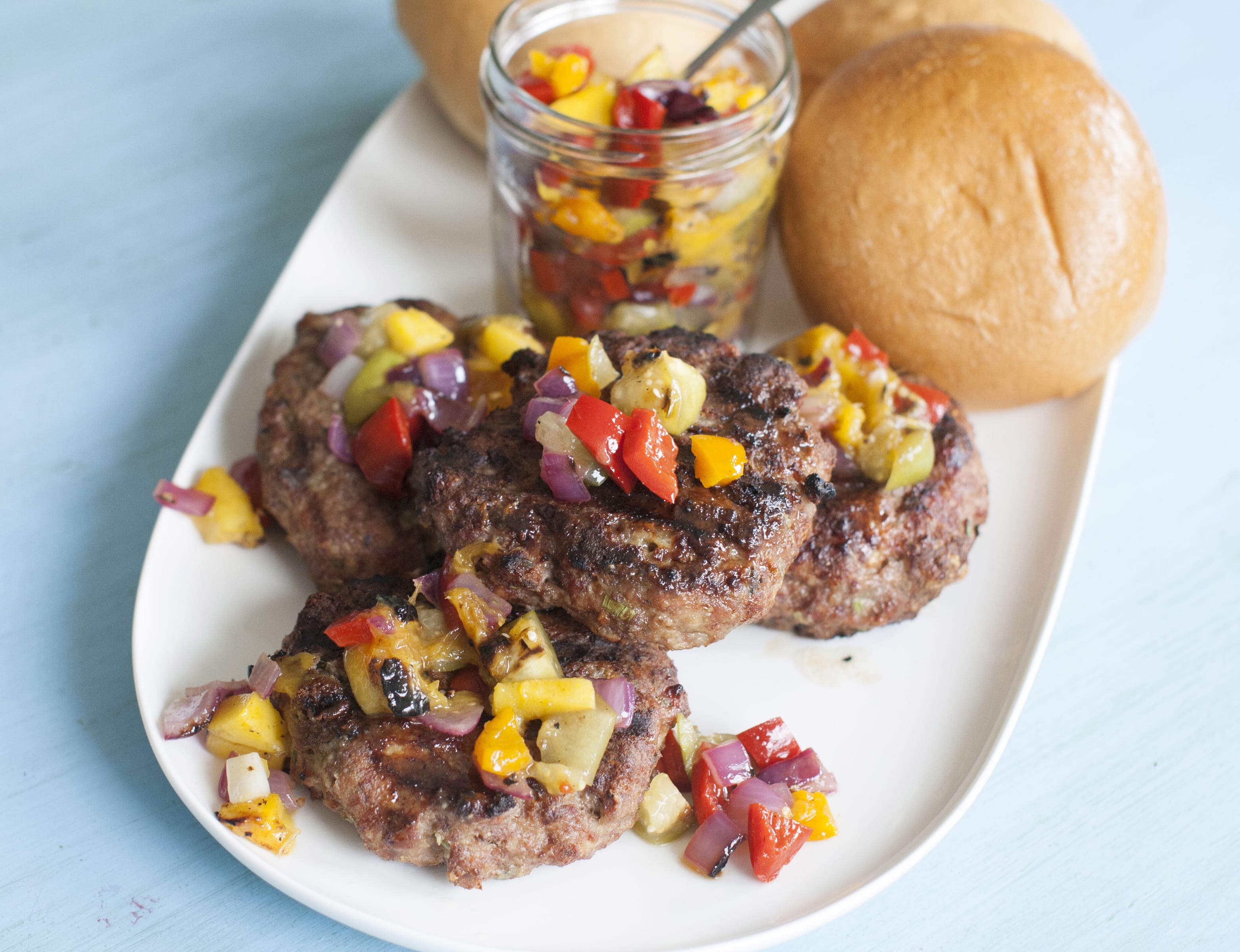Grilled Tomatillo and Mango Salsa Over Blue Cheese Meatloaf Burgers is a summer grilling recipe combines meat, vegetables and fruit.