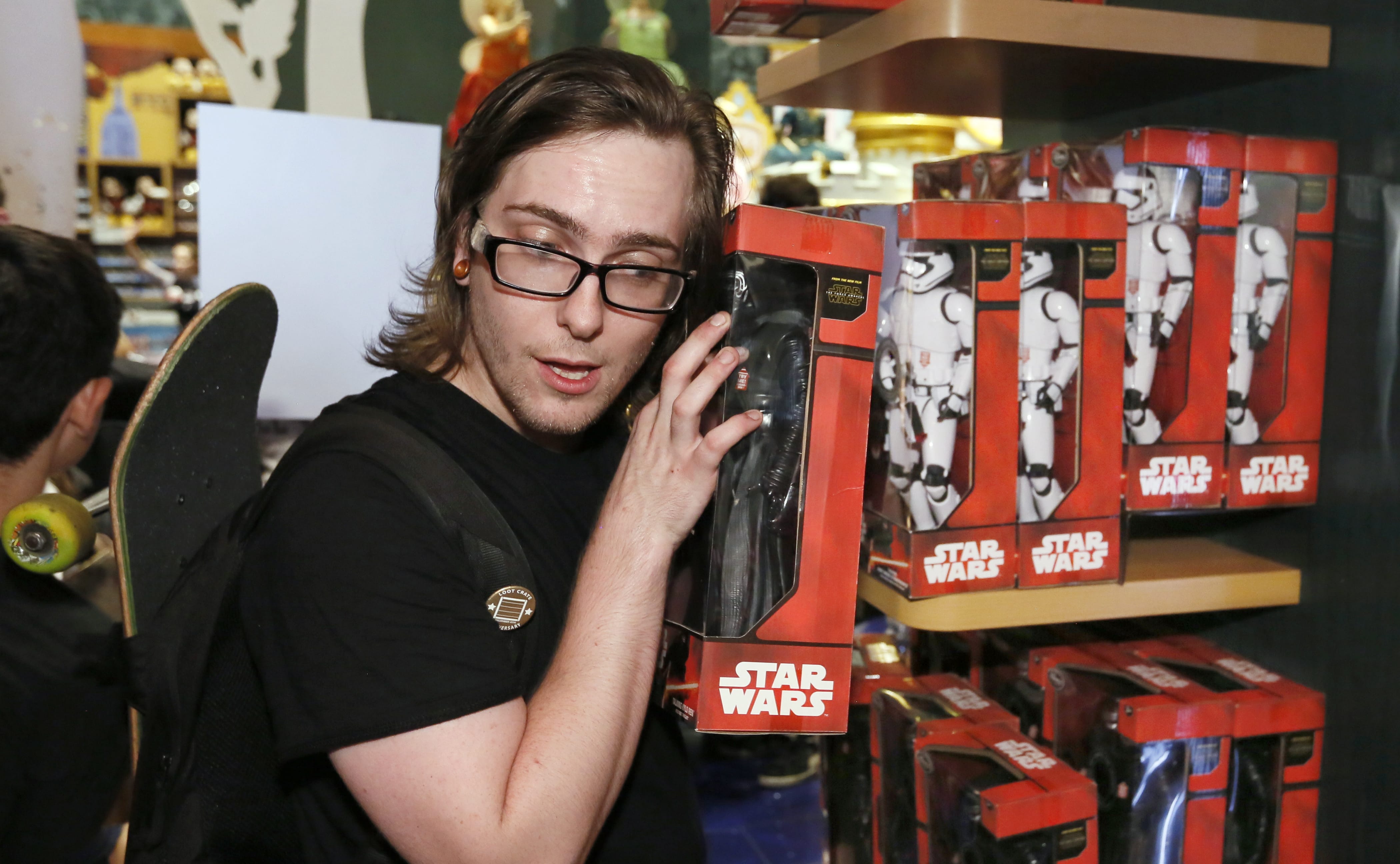 Elijah Catrone, of Queens, N.Y., listens to a talking action figure as Force Friday kicks off at Disney Store in New York's Times Square, on Friday to celebrate the launch of merchandise for "Star Wars: The Force Awakens."