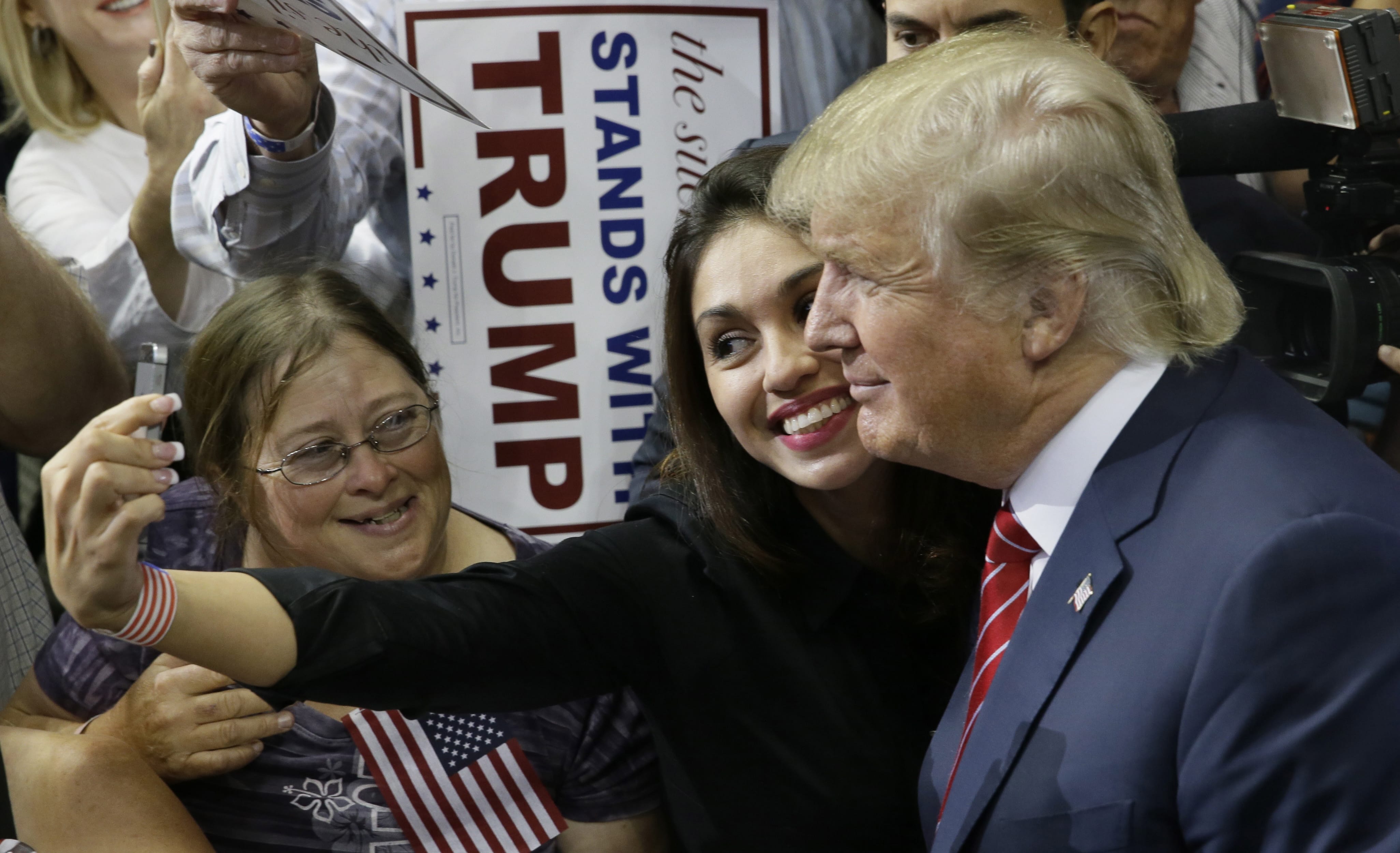 Republican presidential candidate Donald Trump takes a photo with a supporter after speaking at a campaign event in Dallas on Monday.