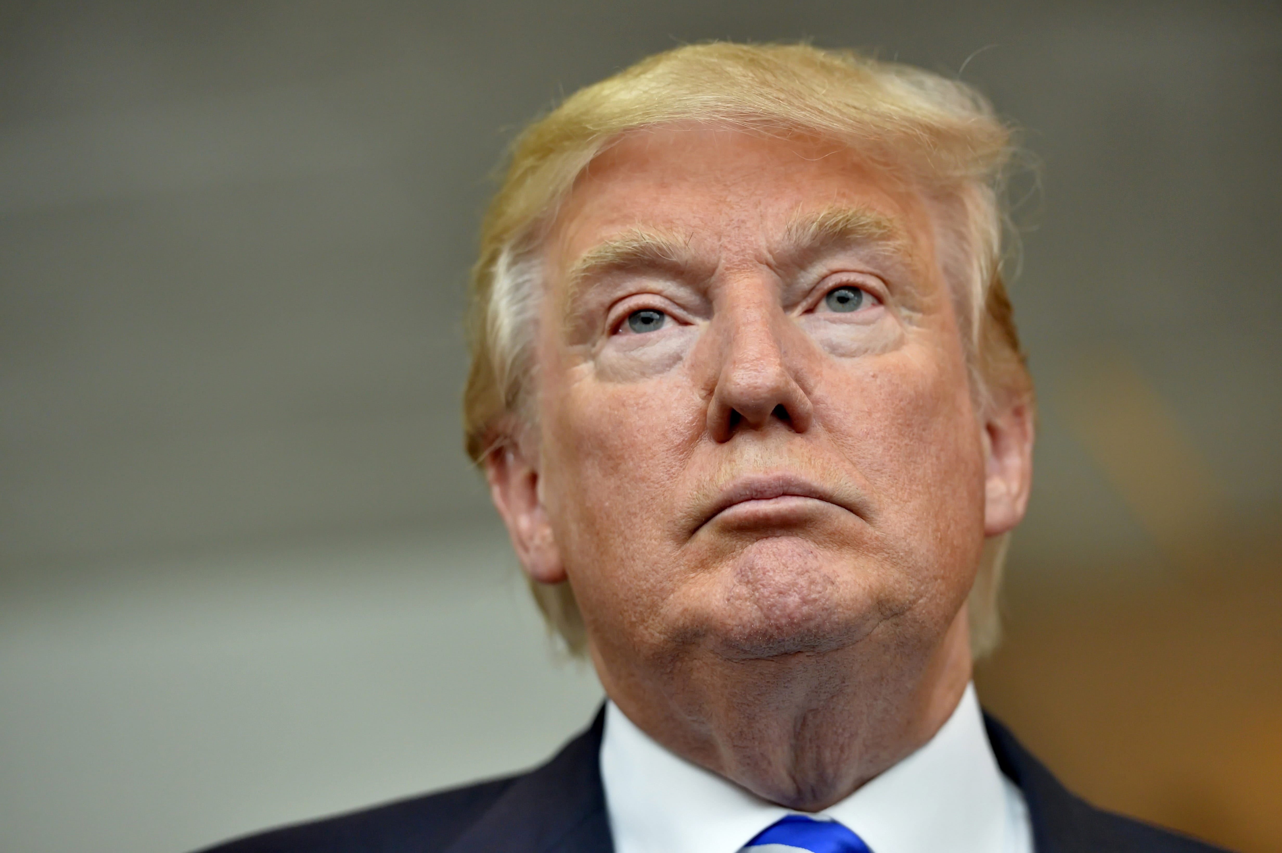 In this Thursday, Aug.  27, 2015, photo, Republican presidential candidate Donald Trump listens during a news conference after speaking at the TD Convention Center, in Greenville, S.C. Trump's call for mass deportation of millions of immigrants living in the U.S. illegally, as well as their American-born children, bears similarities to a large-scale removal that actually happened to many Mexican-American families 85 years ago.