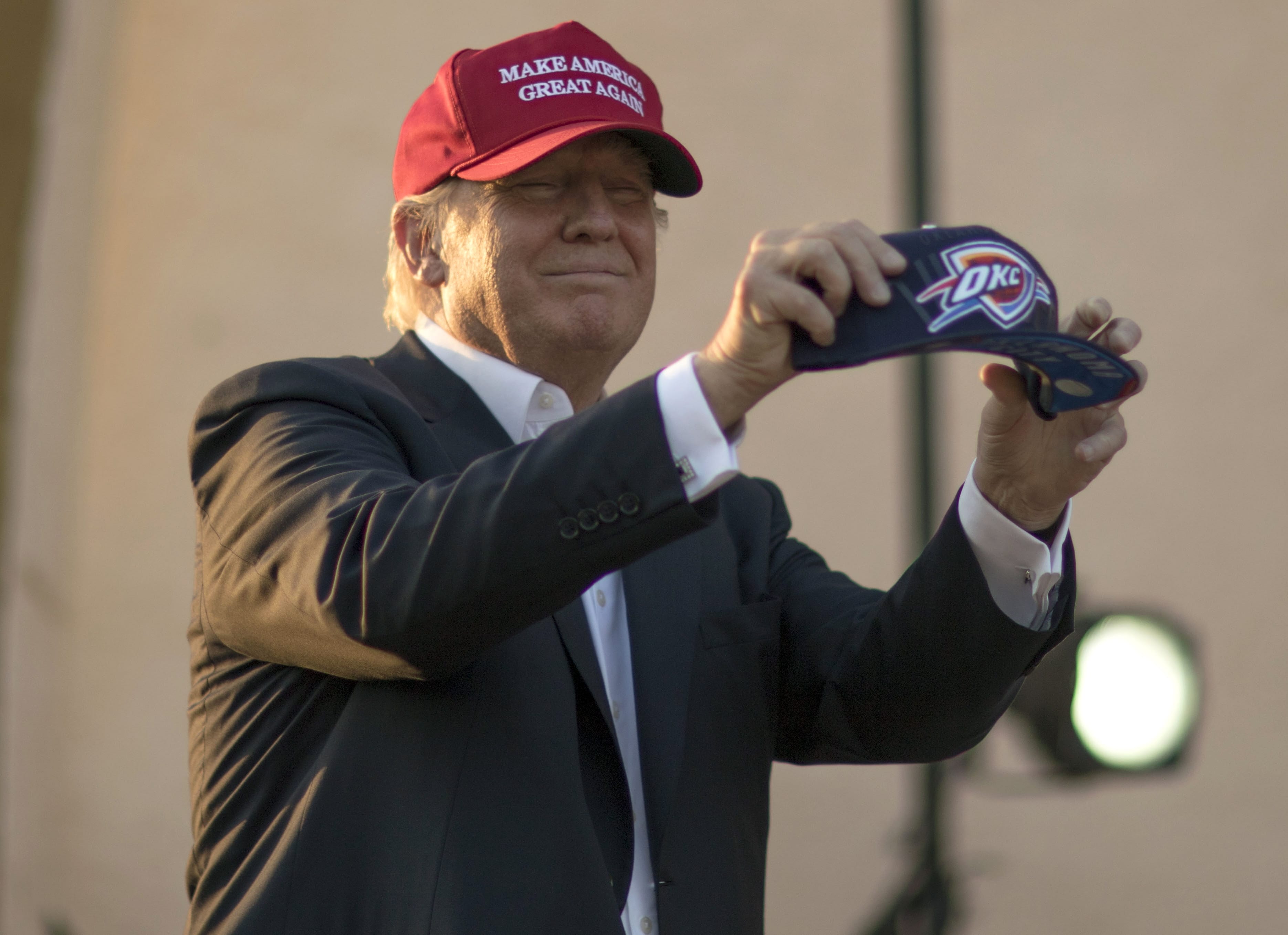 Republican presidential candidate Donald Trump holds an Oklahoma City Thunder basketball hat before speaking at a campaign rally at the Oklahoma State Fair on Friday in Oklahoma City.