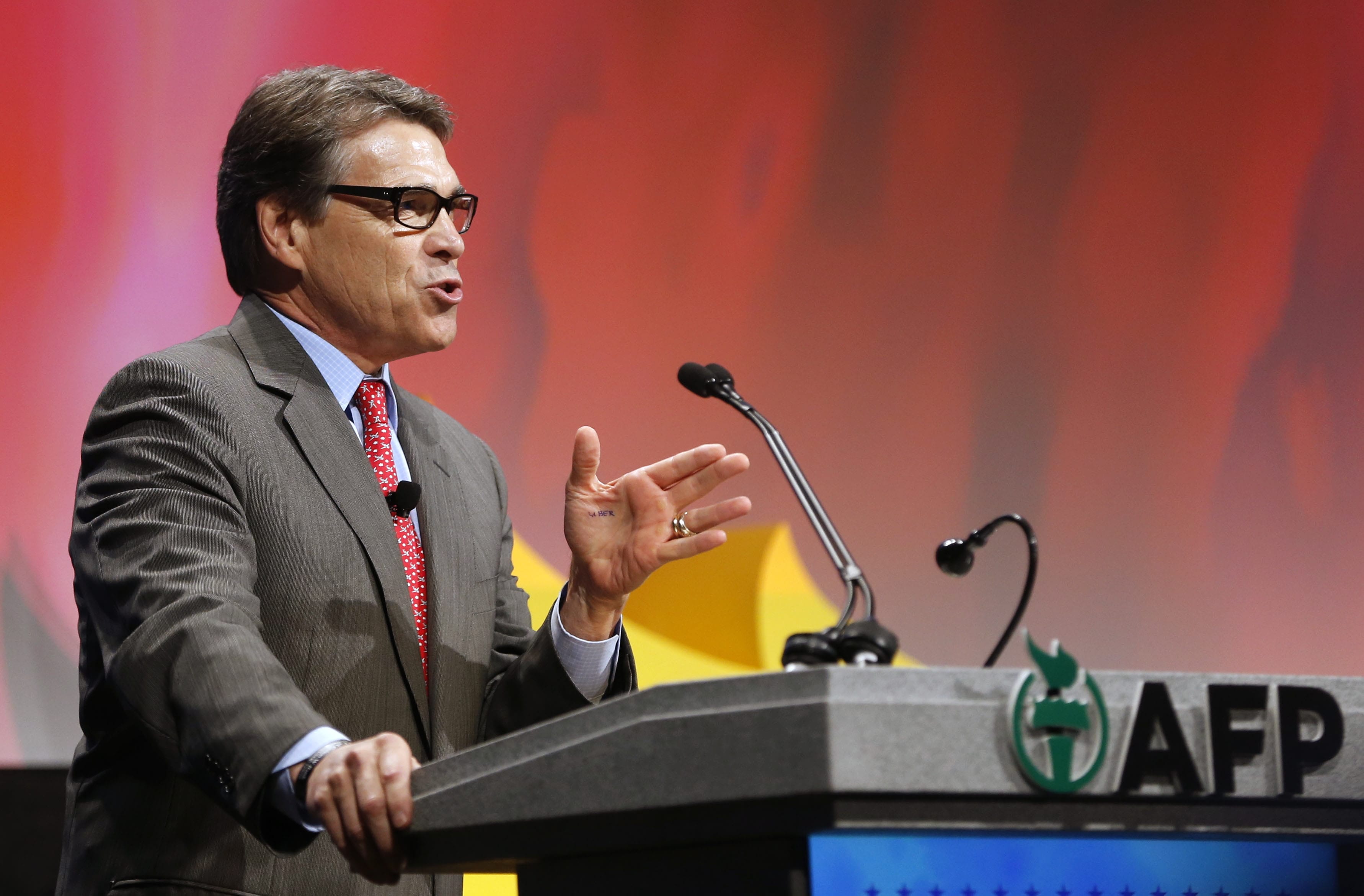 Governor Rick Perry with the word &quot;uber&quot; written on his hand as he speaks at the Americans for Prosperity conference at the Omni Dallas Hotel in Dallas, Texas on Friday.