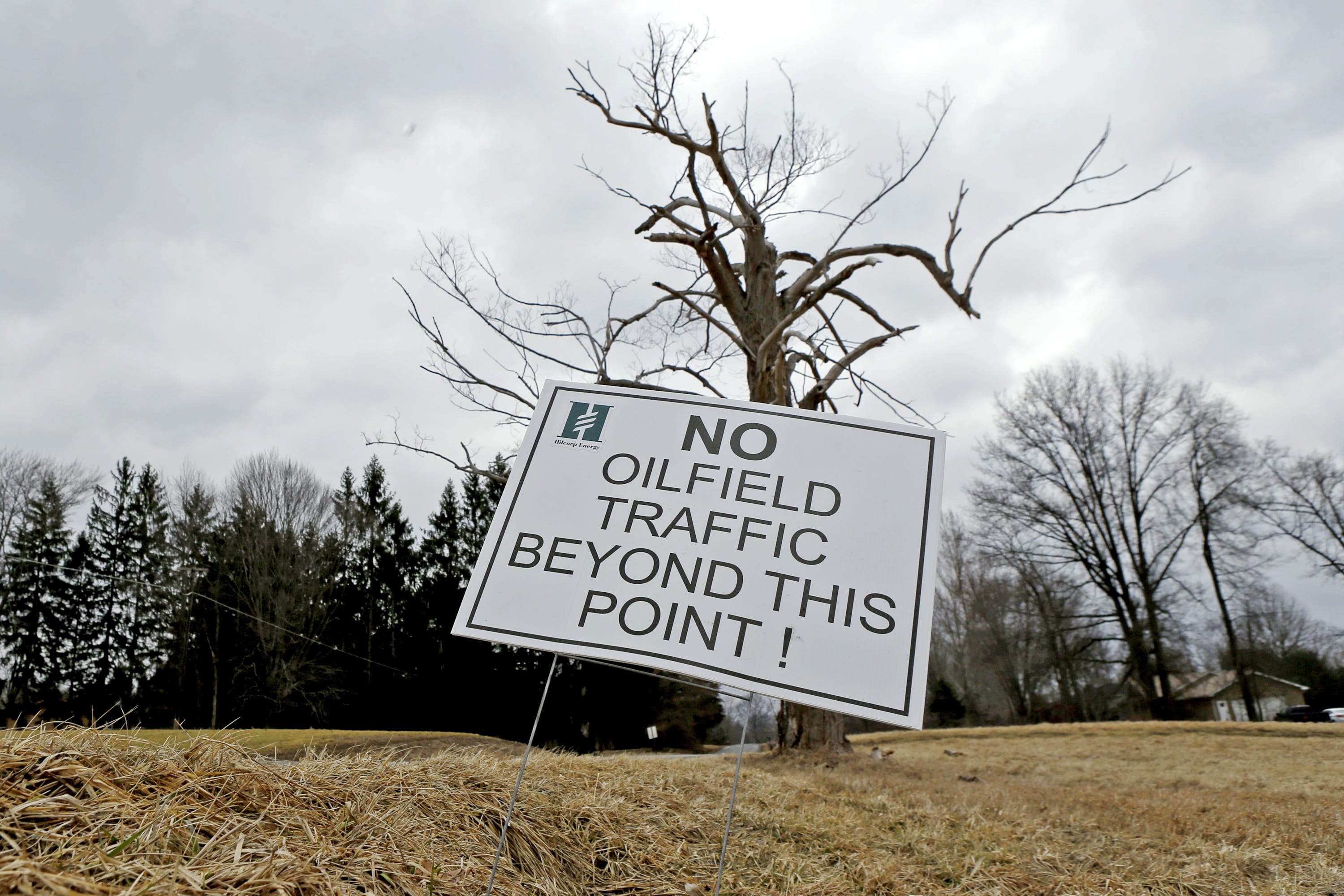 A sign near a gas well drilling site near a road in Pulaski, Pa.