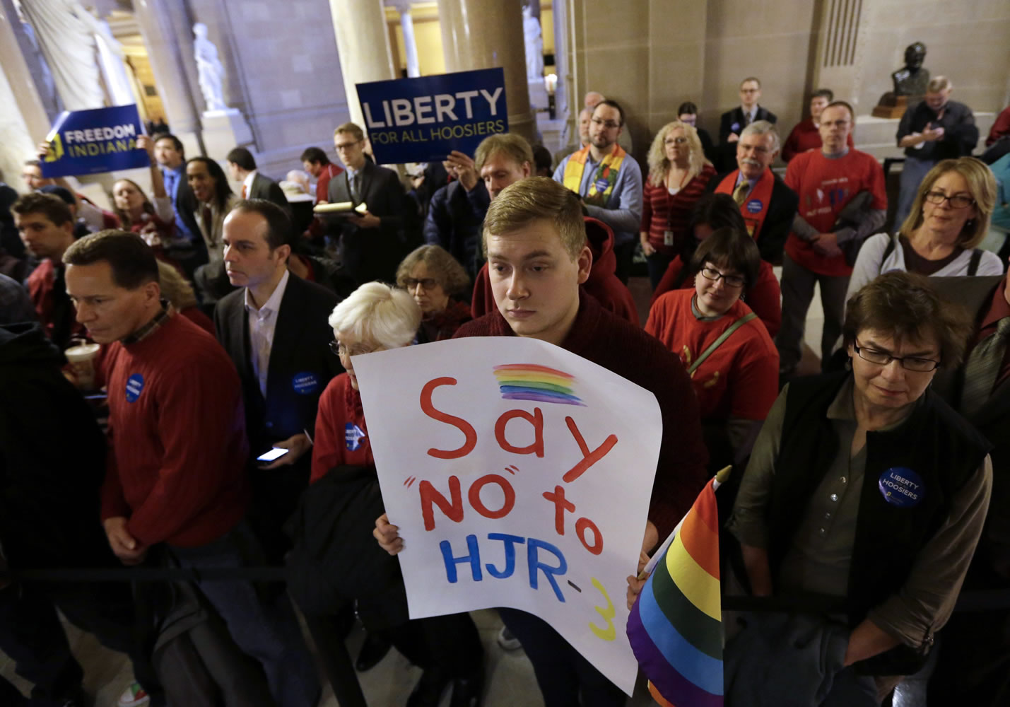 Dylan Hutson, center, of Indianapolis holds a sign voicing his opposition to a measure amending the stateu2019s constitution to ban gay marriage at the Statehouse in Indianapolis in January.