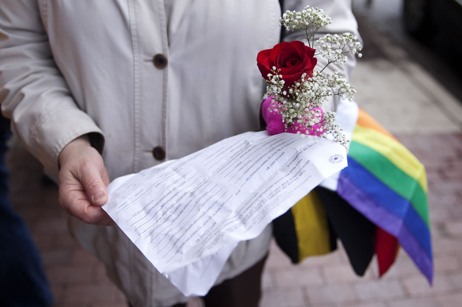 Rhonda Stoner of Ypsilanti, Mich., holds an application for a marriage license as she waits Saturday at the Washtenaw County Clerks office in Ann Arbor, Mich.